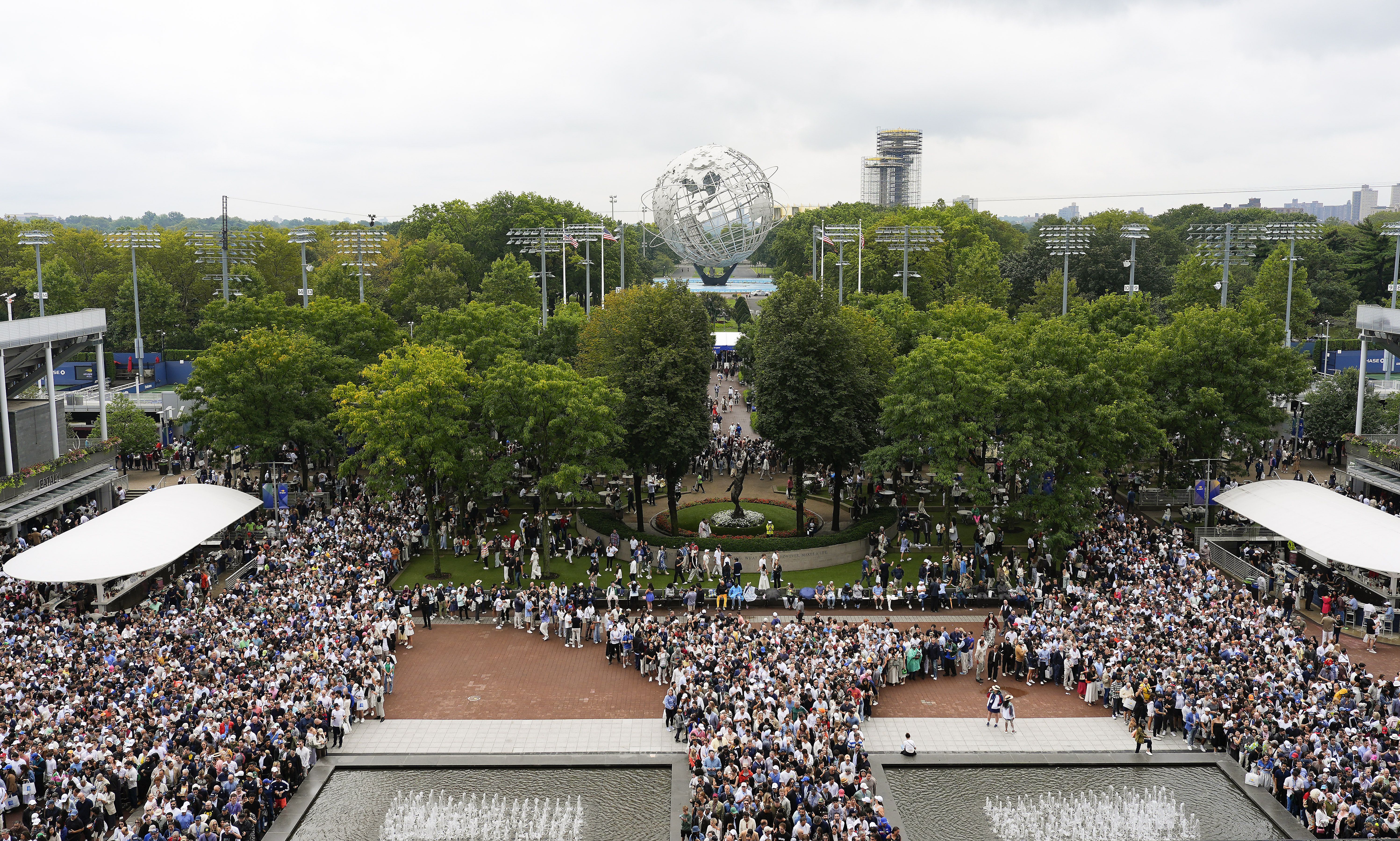 Tennis fans line up to get into Arthur Ashe Stadium to watch Carlos Alcaraz win the U.S. Open final over Jannick Sinner in New York yesterday.