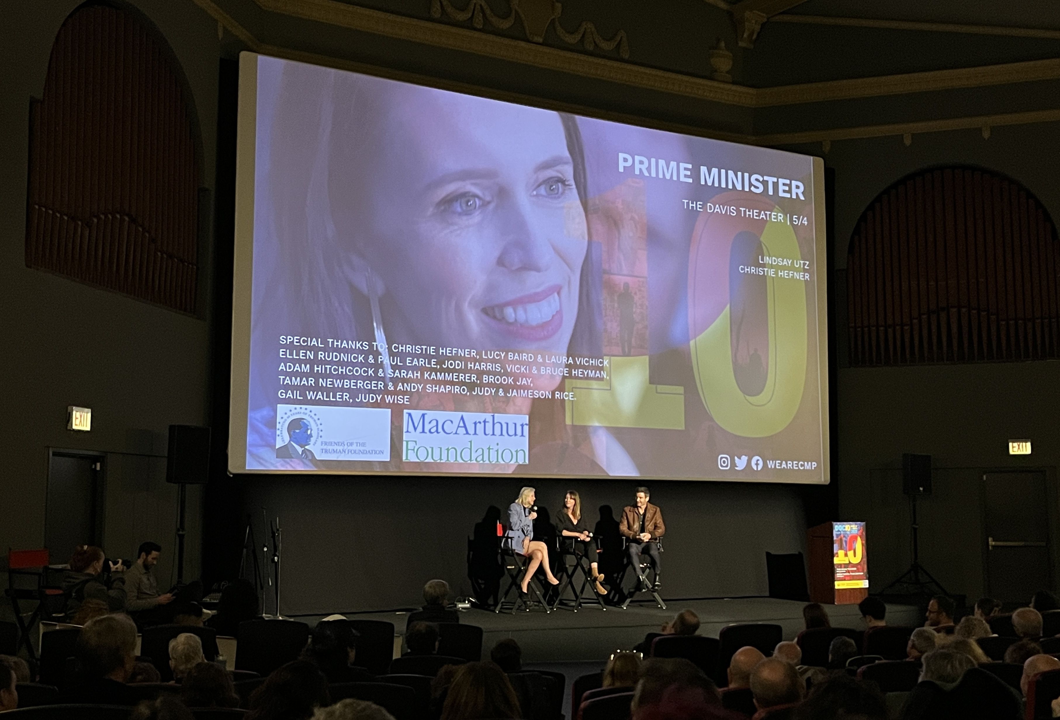 movie screen with people underneath