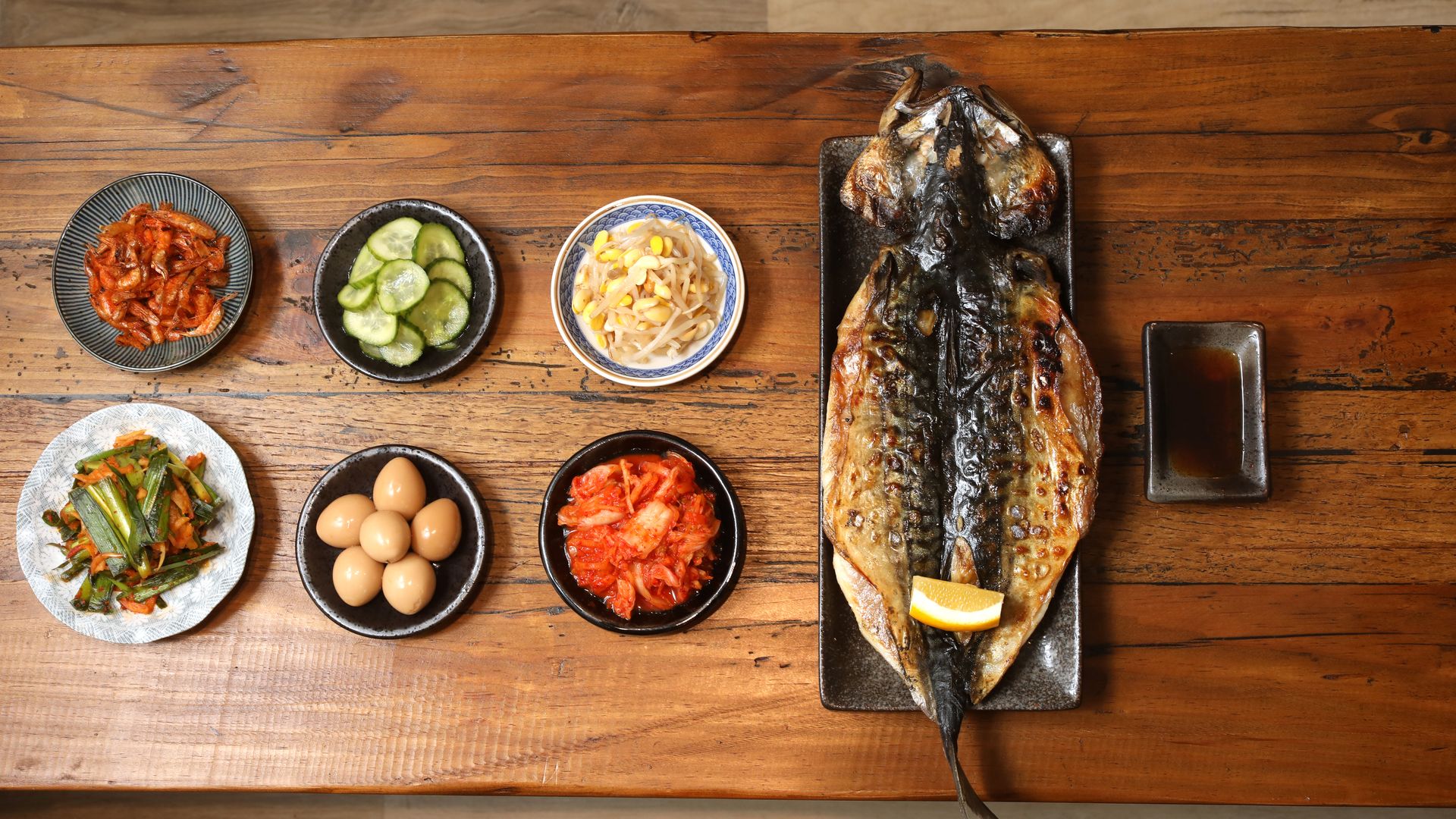 Charcoal grilled korean BBQ Mackerel seen with banchan at Um.ma, Chris Oh's restaurant in the Sunset dedicated to homestyle Korean cooking on Friday, July 26, 2019 in San Francisco, Calif. (Photo By Liz Hafalia/The San Francisco Chronicle via Getty Images)