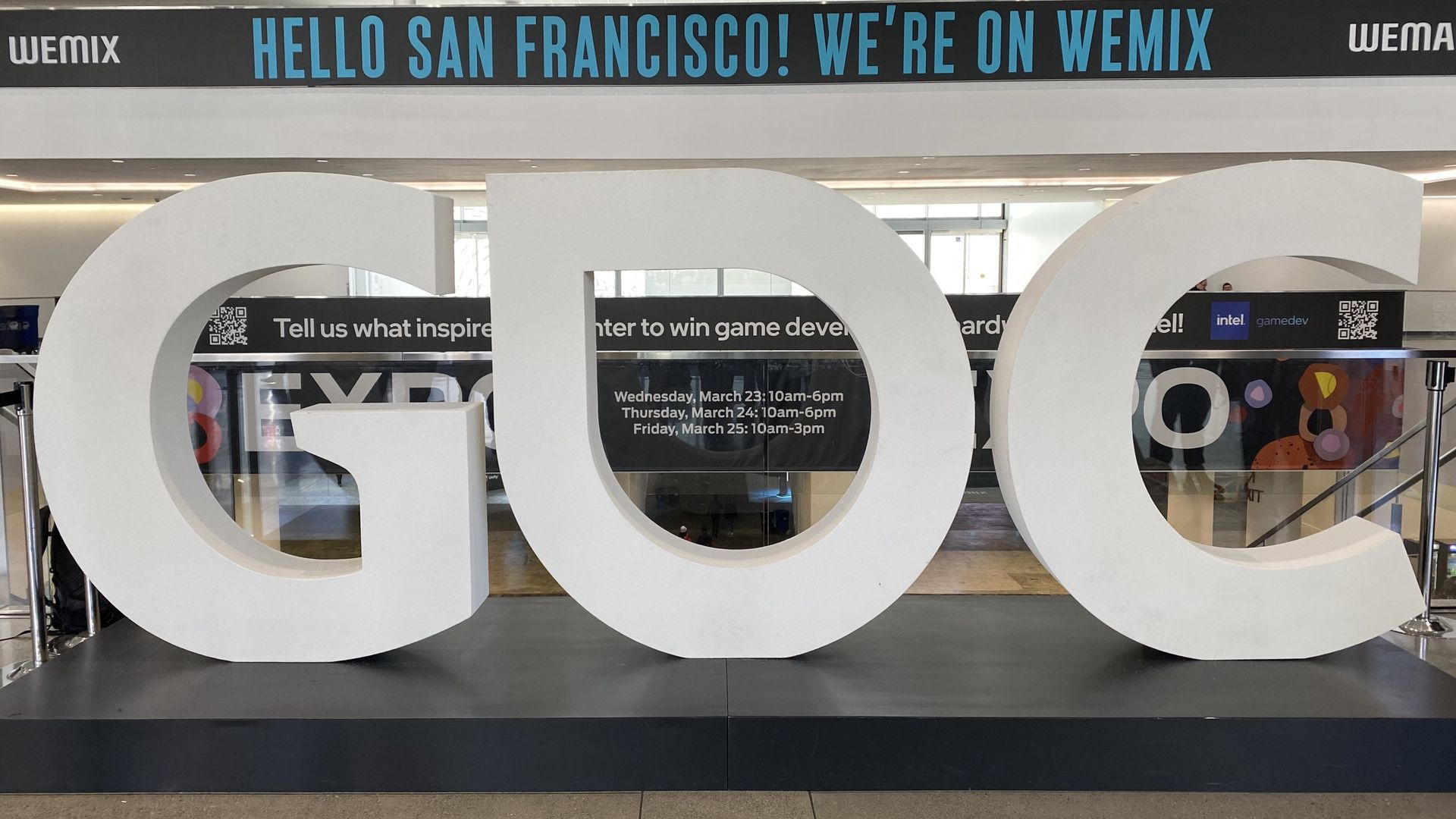A sign composed of three large letters, G, D and C, below another sign that says "Hello San Francisco"