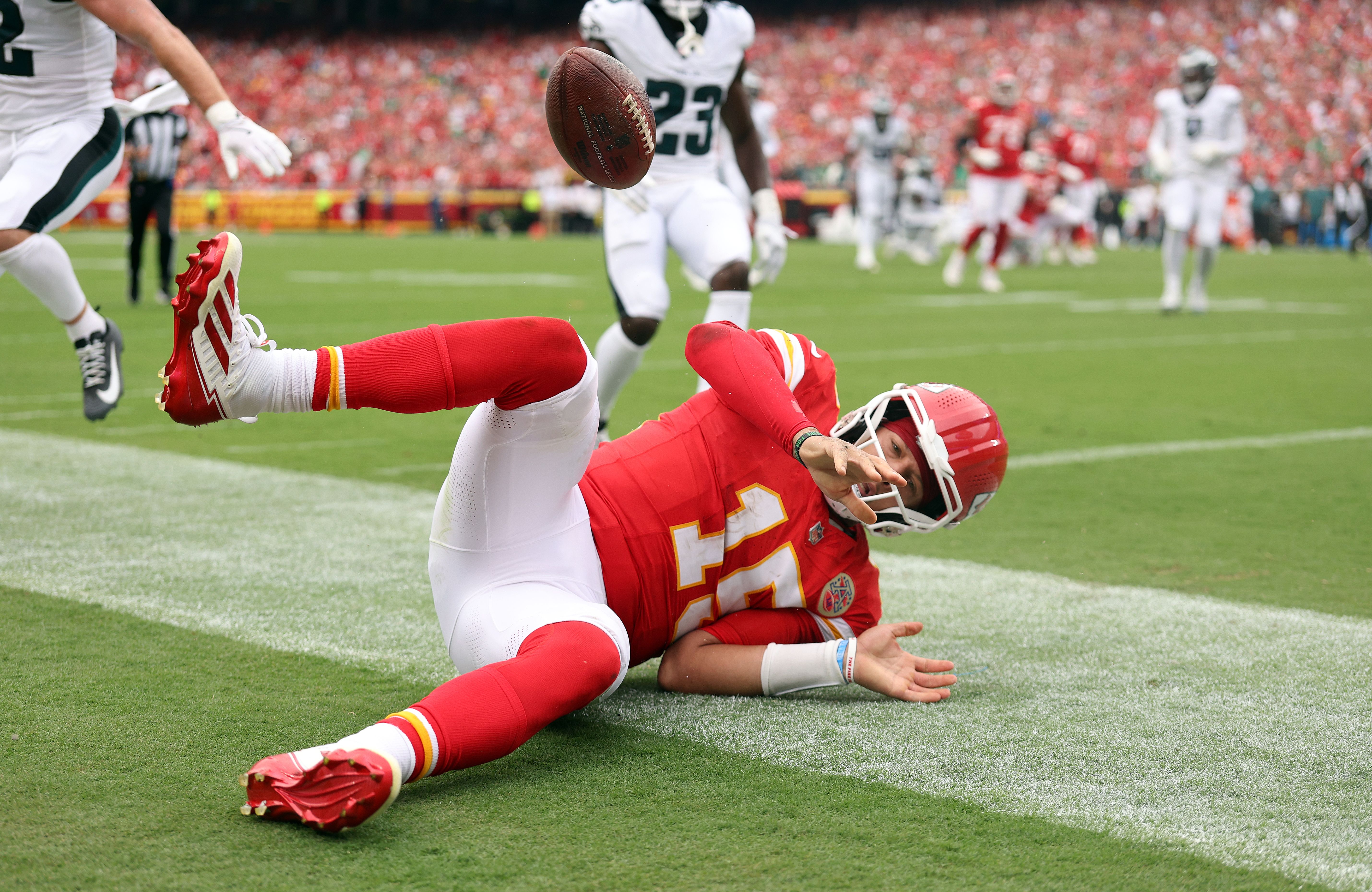 Patrick Mahomes #15 of the Kansas City Chiefs lies on the ground with the ball in the air as he scores a touchdown against the Philadelphia Eagles during the second quarter in the game at Arrowhead Stadium on September 14, 2025 in Kansas City, Missouri.