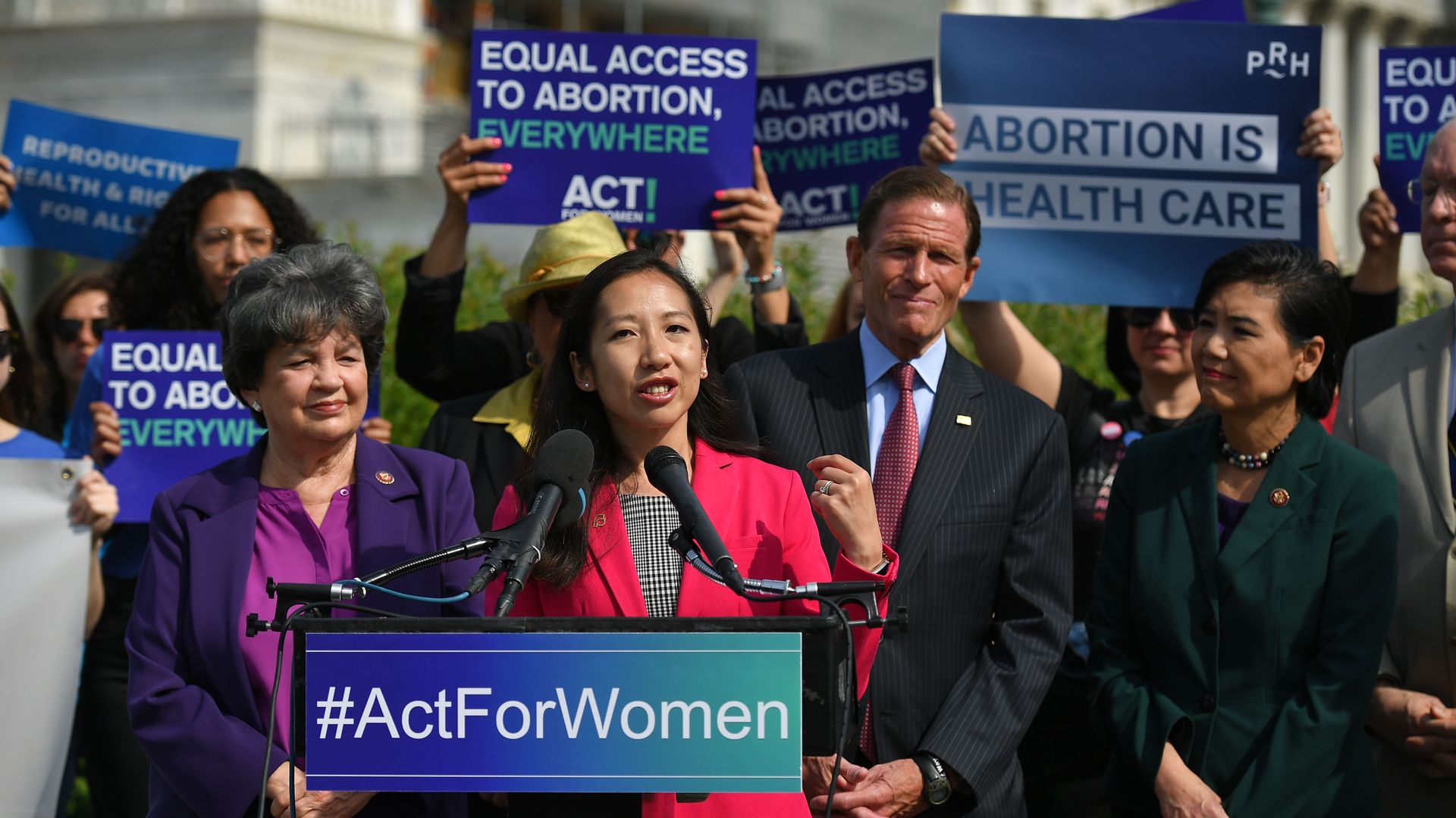 In this image, Wen stands and speaks at a rally