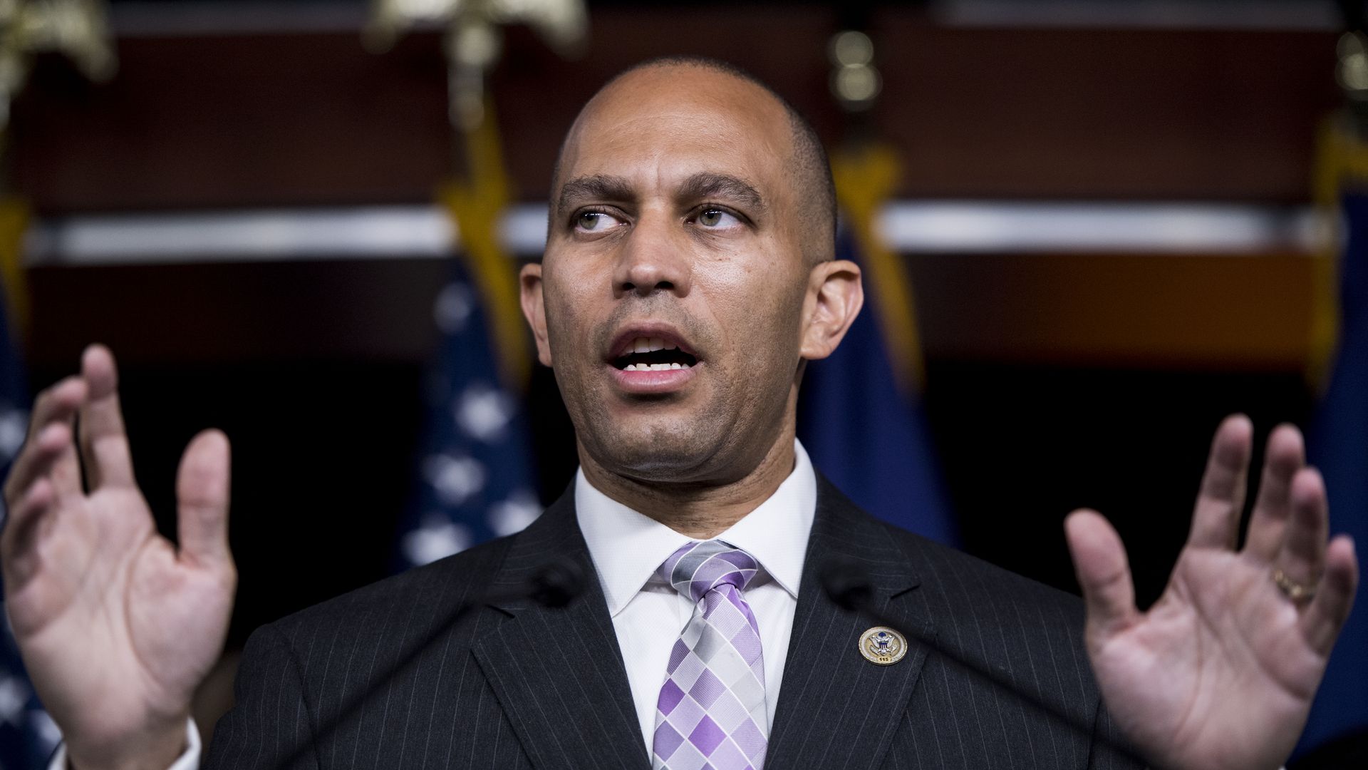 Rep. Hakeem Jeffries with his mouth open and hands up by his sides. 