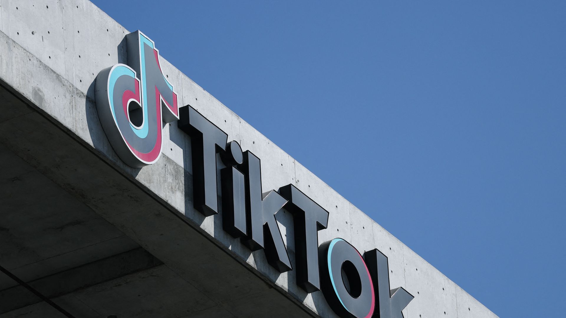 TikTok logo is pictured on a building outside. 