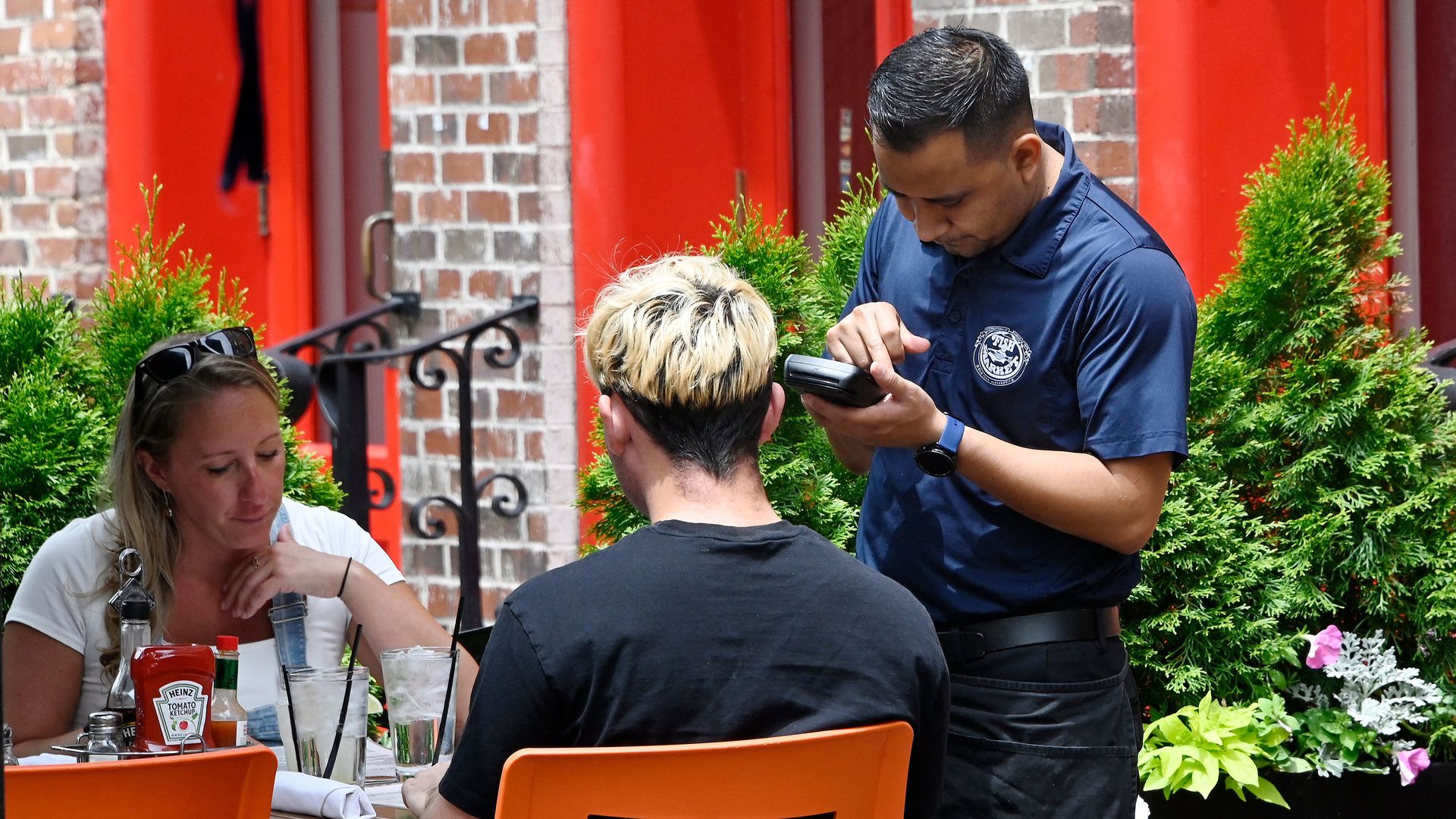 A waiter working at a restaurant in Alexandria, Virginia, on June 3.