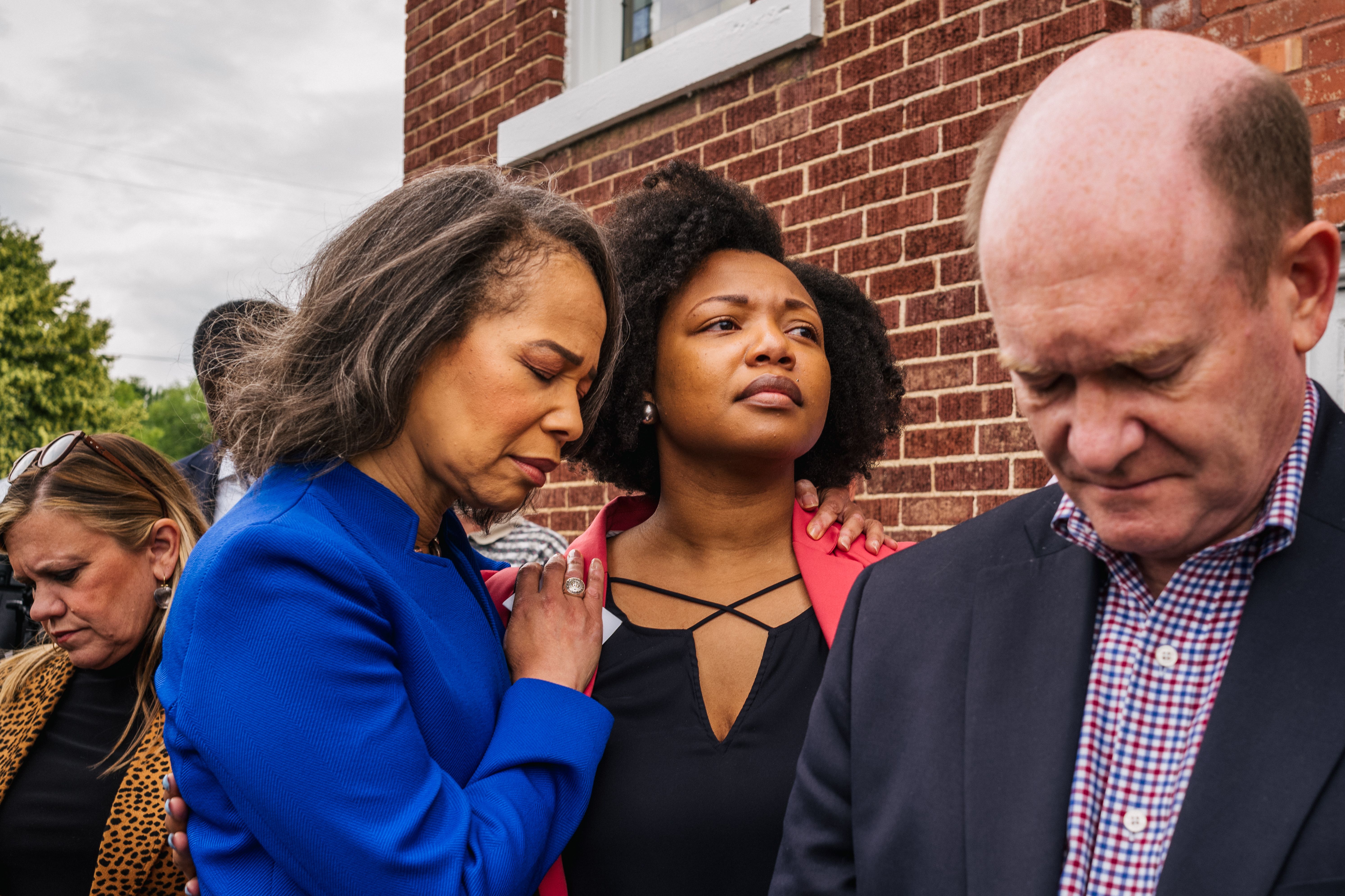 Rep. Lisa Blunt Rochester (D-DE) (L) and Sen. Chris Coons (D-DE) participate in a prayer at the AME Church in the Greenwood district during commemorations of the Tulsa Race Massacre on May 31