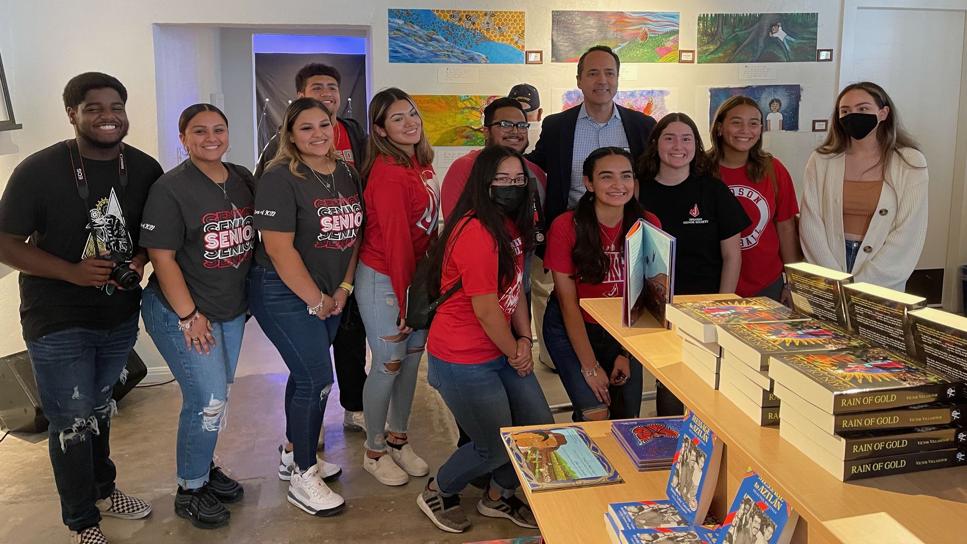 Texas State Sen. José Menéndez (D-San Antonio) poses with children at the Guadalupe Latino Bookstore in San Antonio, Texas.