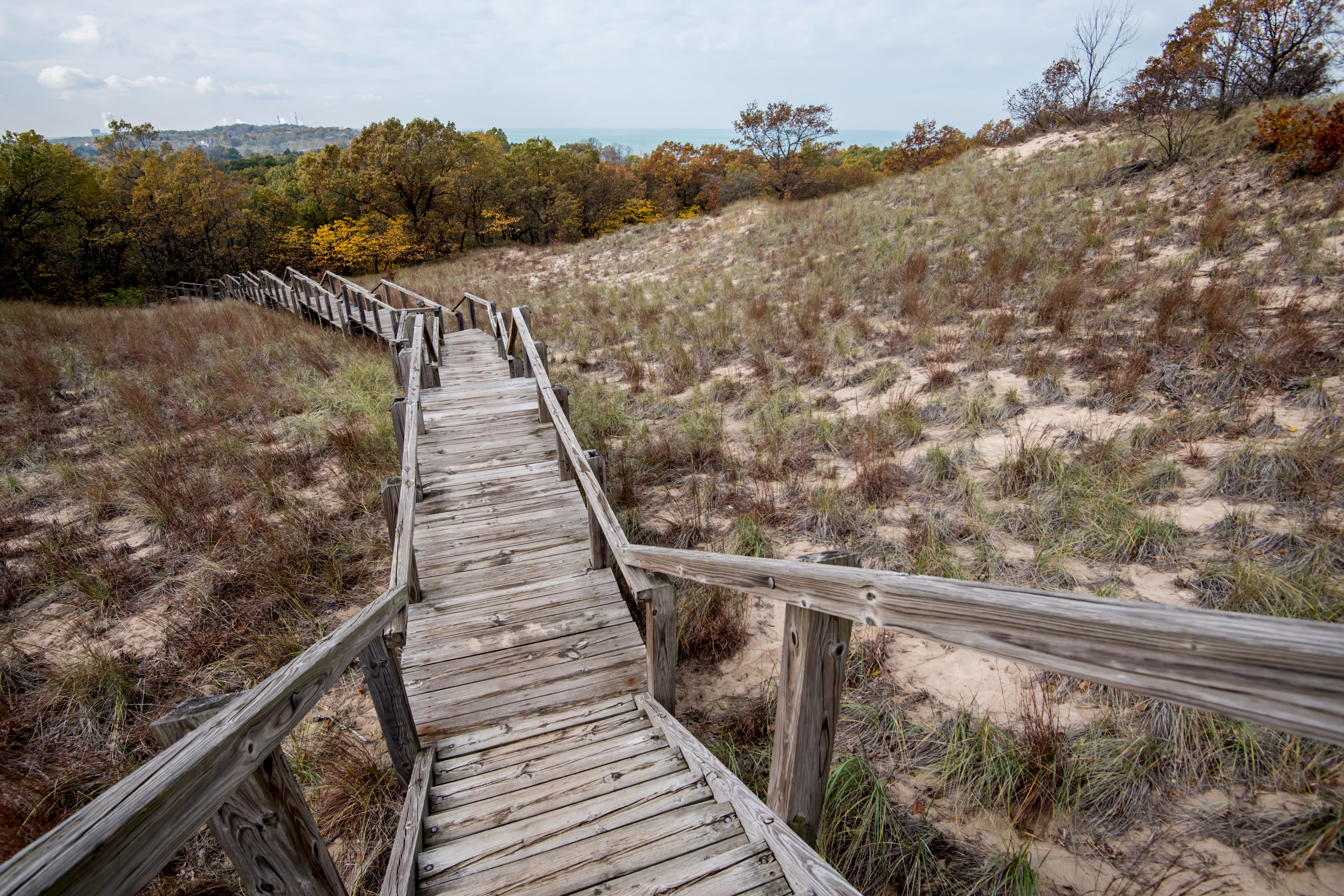 Photo of stairs heading down to hills and to a lake 