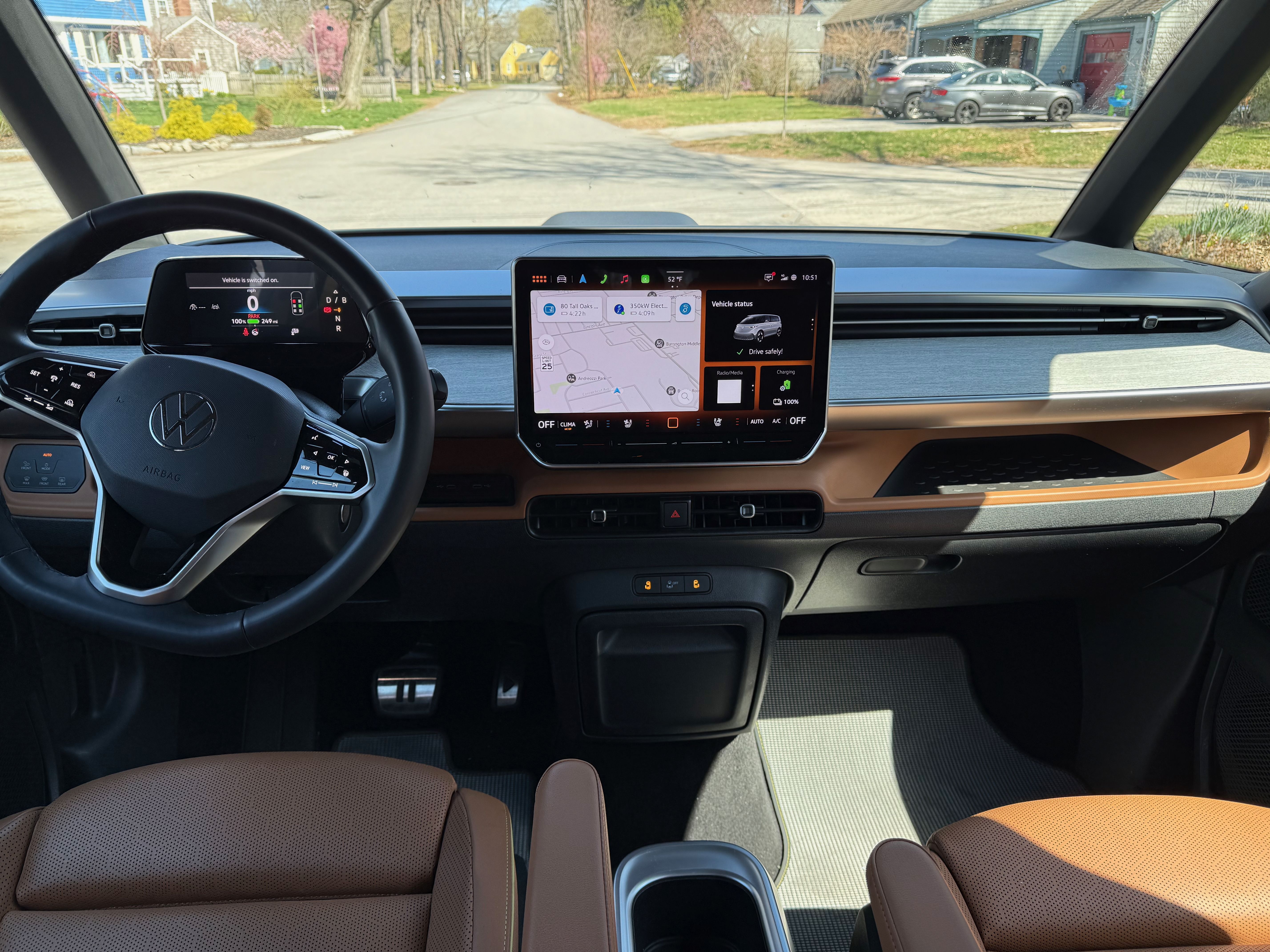 A photo of the interior of the VW ID.Buzz, featuring brown leather seats and a central screen.