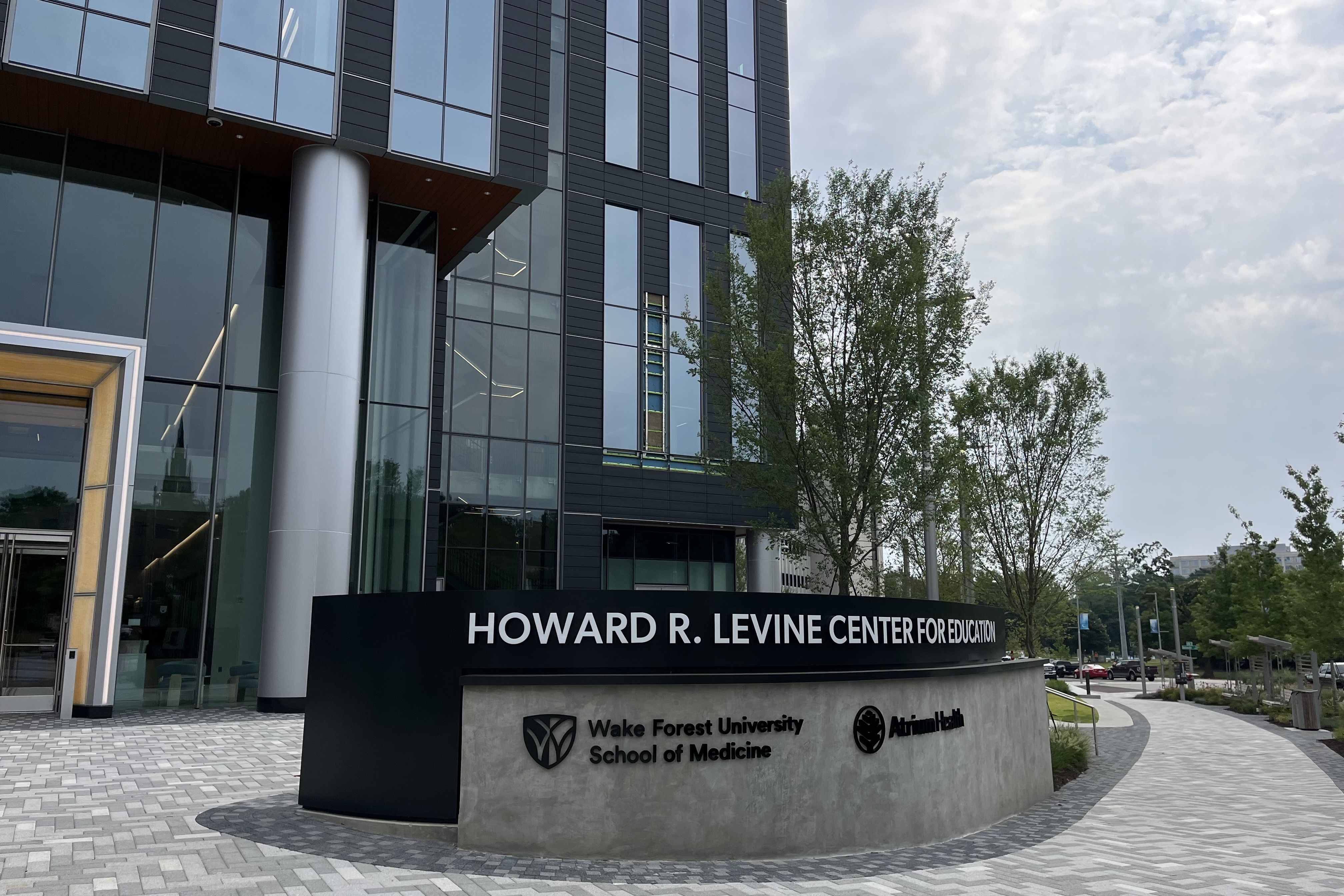 The sign outside a building says "Howard R. Levine Center for Education"
