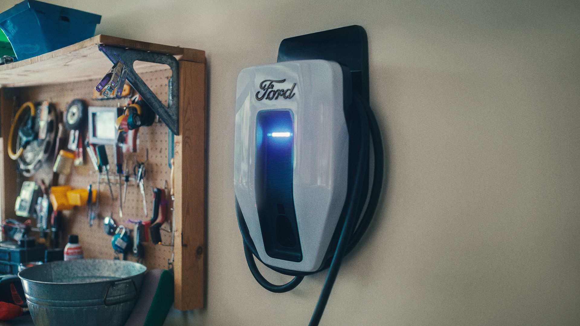 An EV charging station on the wall of a garage