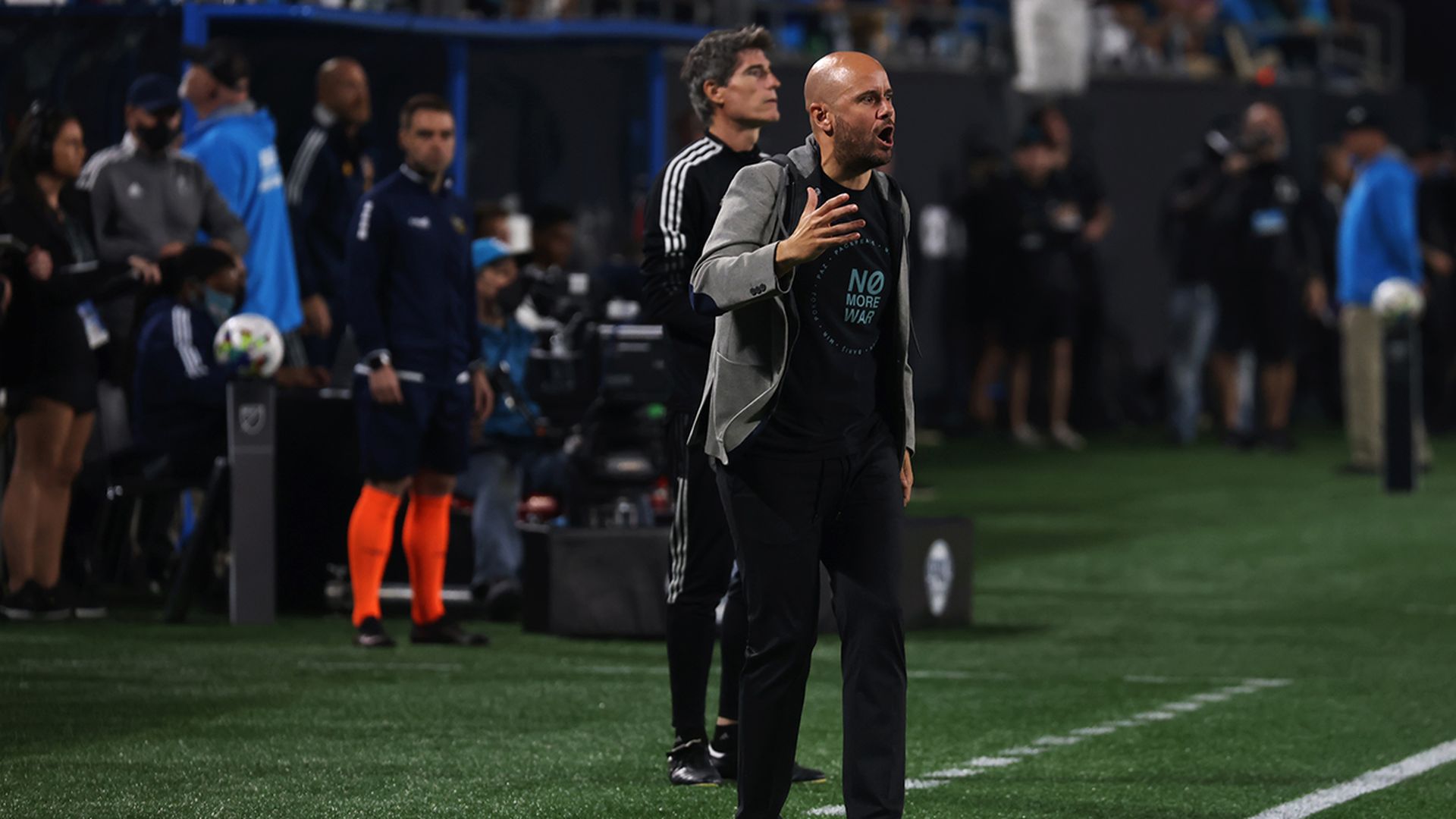 Charlotte FC head coach Miguel Ăngel RamĂrez's shirt said "No More War" during the club's home debut vs. LA Galaxy on March 5. Photo: Travis Dove/Axios