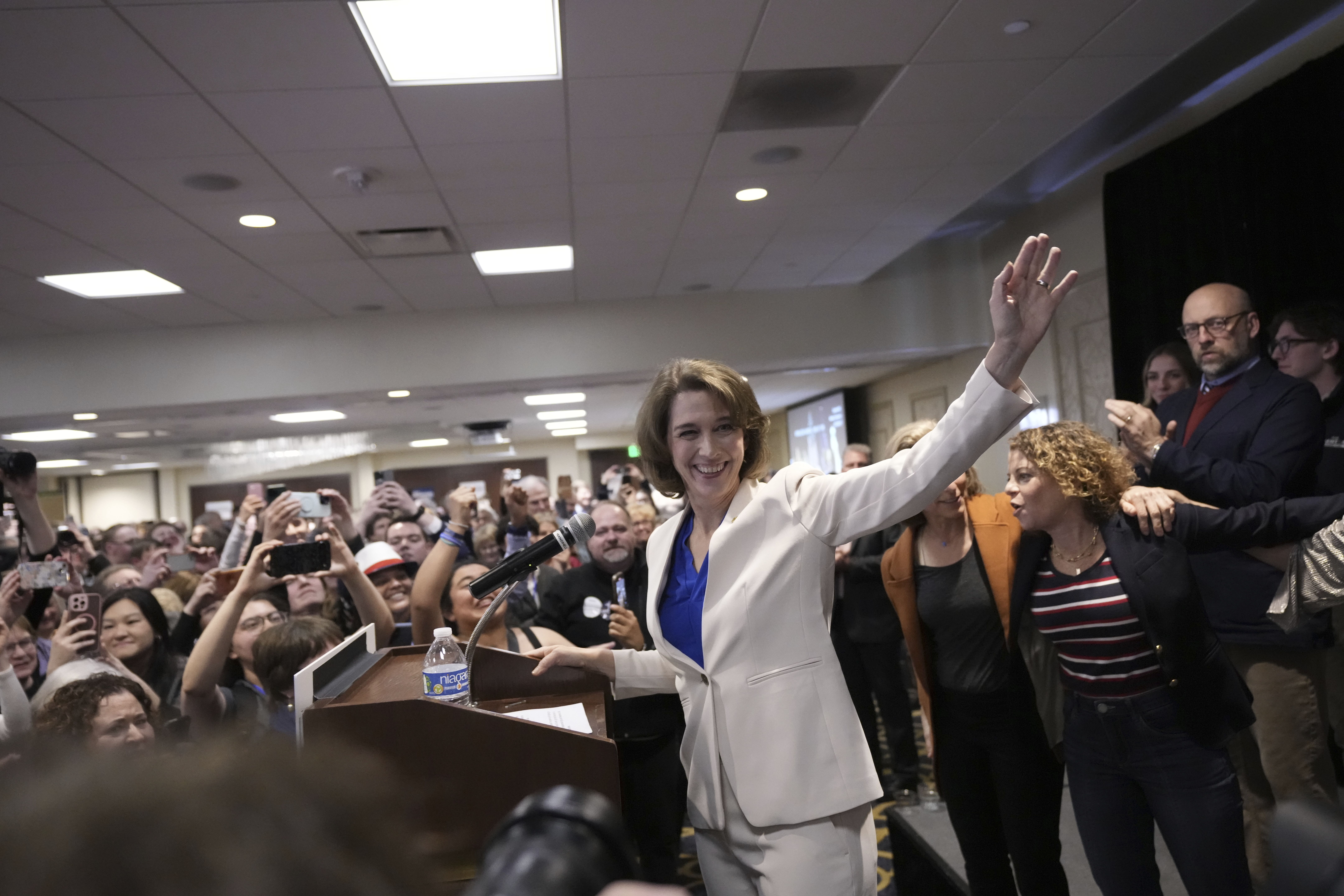 Susan Crawford waves during her campaign party after winning a seat on the Wisconsin Supreme Court.