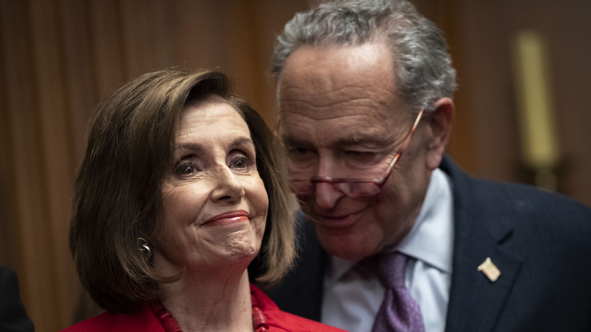 House Speaker Nancy Pelosi and Senate Minority Leader Chuck Schumer stand next to one another at a news conference.