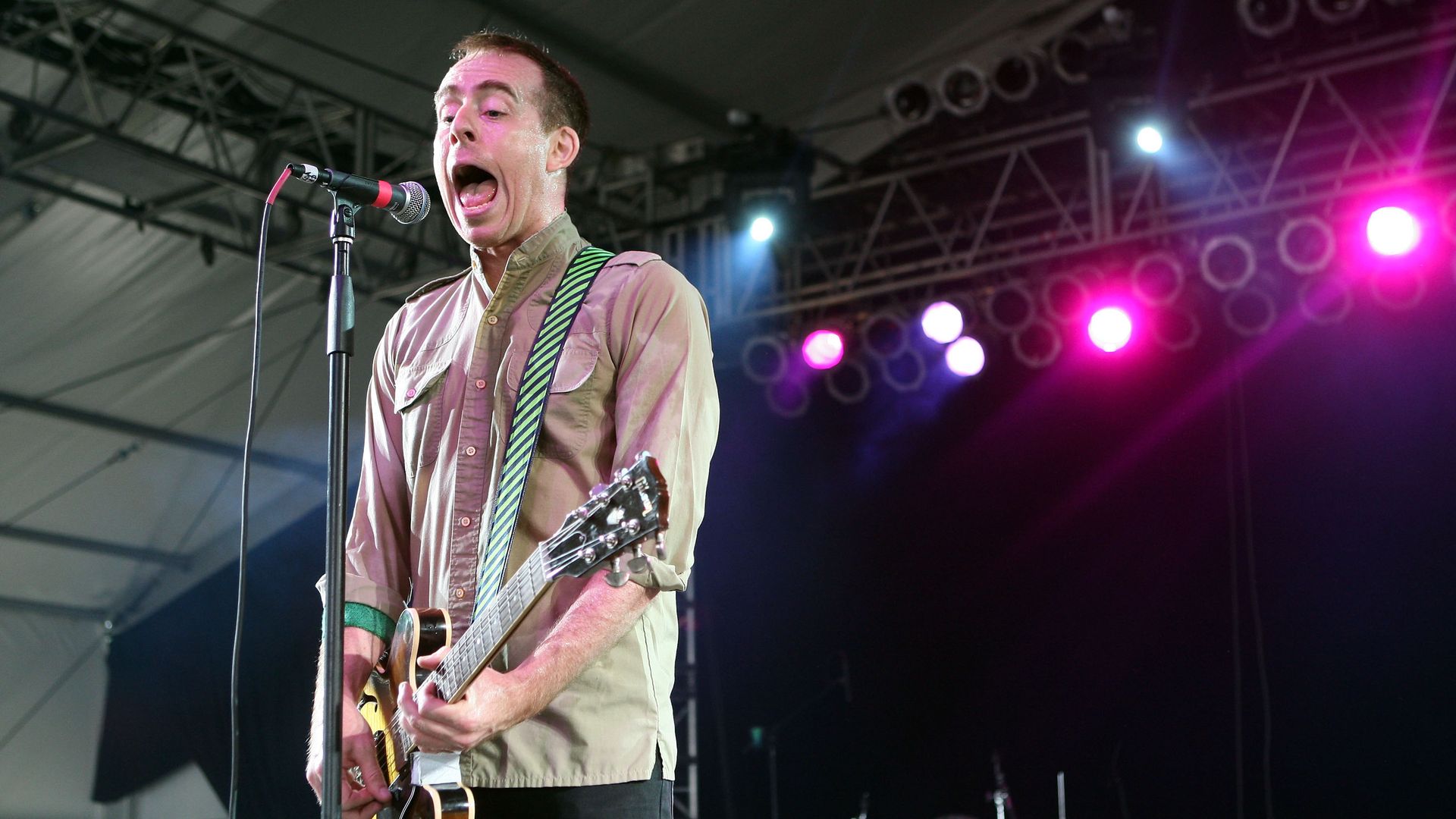 Indie rock singer Ted Leo performs on stage.