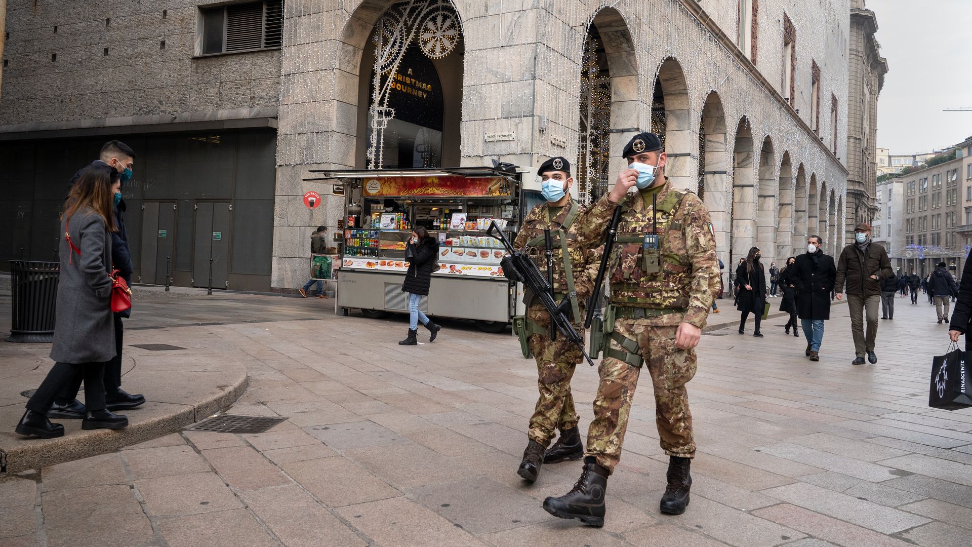 Two soldiers wearing face mask patrol Duomo Square in Milan, Italy 