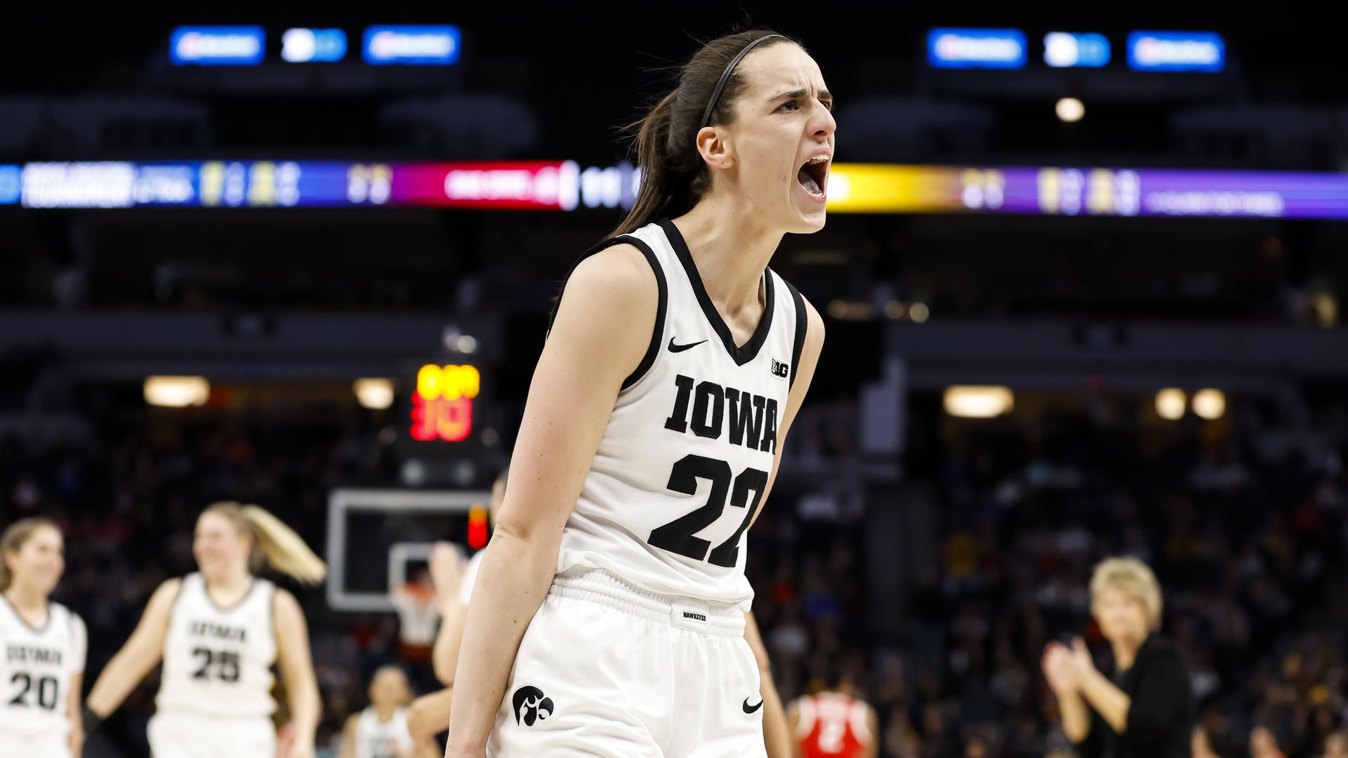 Caitlin Clark screams during a basketball game 