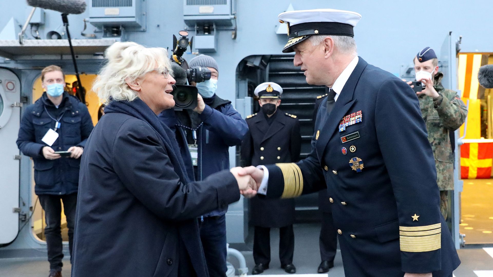 German Defence Minister Christine Lambrecht is welcomed by vice-admiral Kay-Achim Schoenbach 