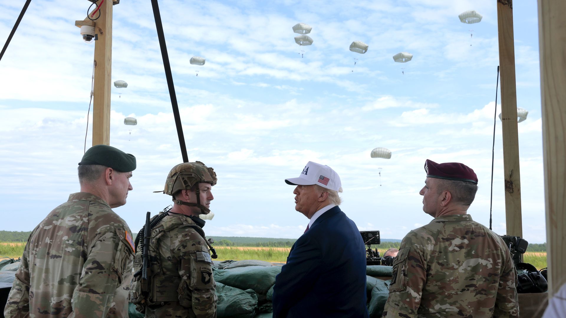 President Donald Trump and Lt. Gen. Gregory Anderson observe Special Operations soldiers during a demonstration at Holland Drop Zone at Fort Bragg, North Carolina.