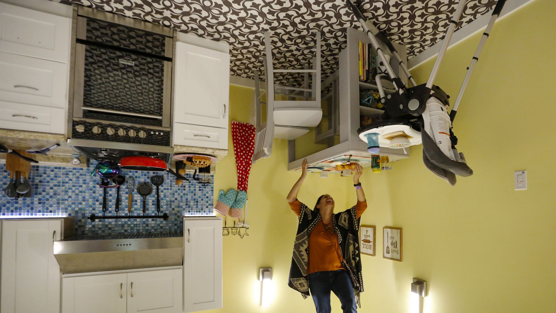 A woman is in an upside down room 