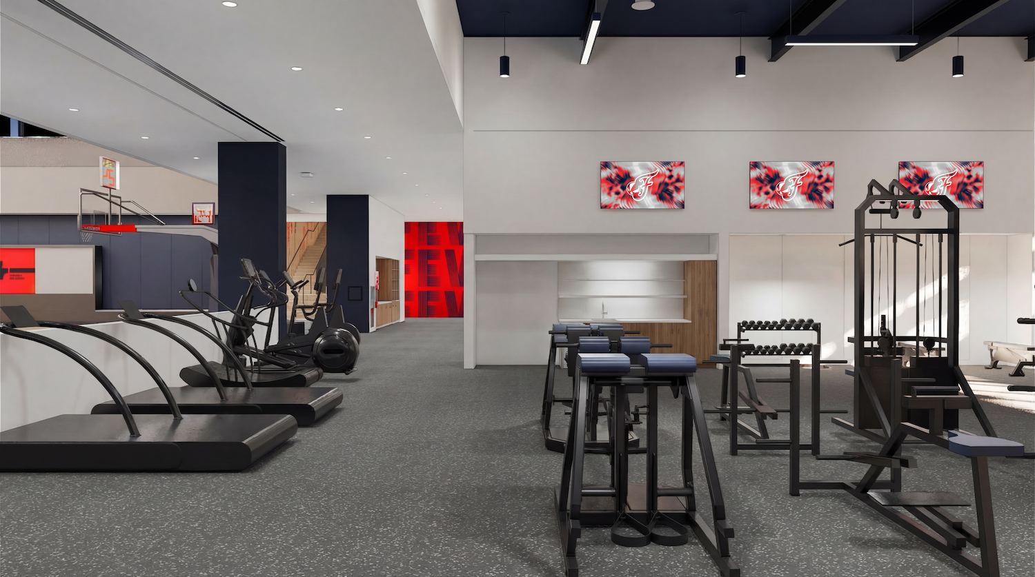 Spacious modern gym with cardio treadmills along the left, free weights and weight machines on the right, gray speckled flooring, and wall monitors displaying a red-and-blue logo.