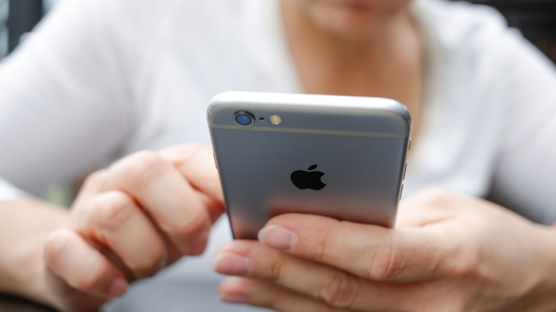 An unidentifiable person using an iPhone