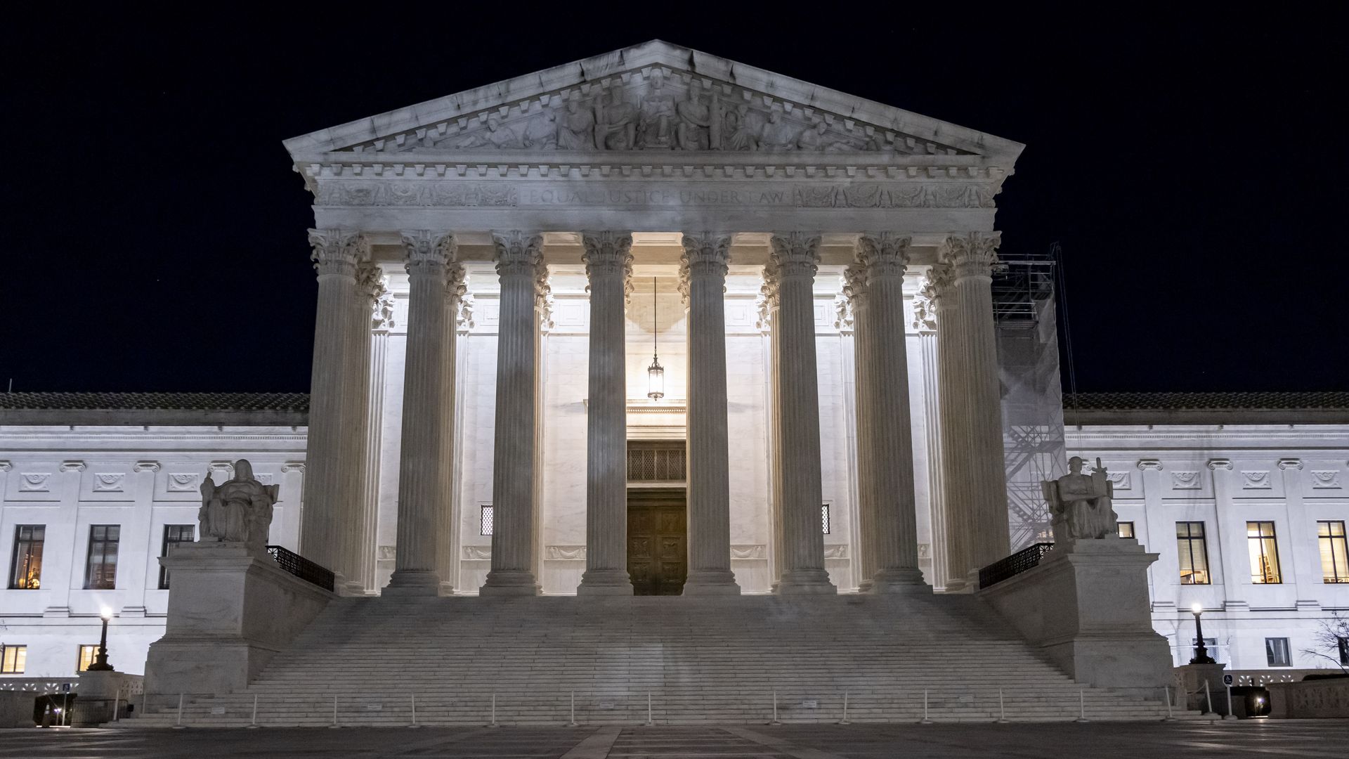 Outside facade of the United States Supreme Court at night.