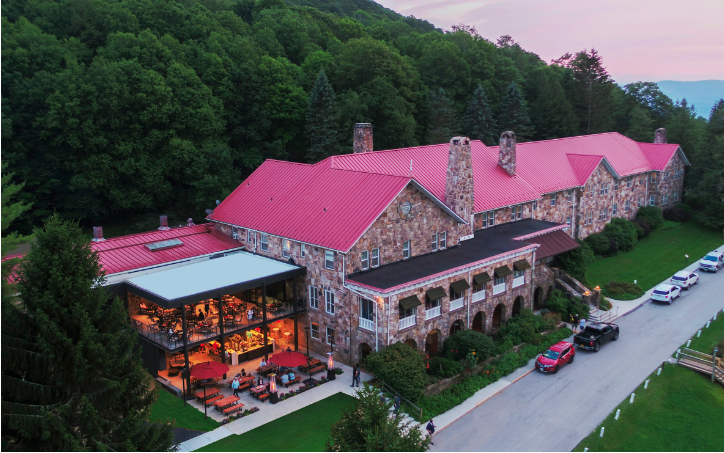 a stone mountain lodge with a pink roof