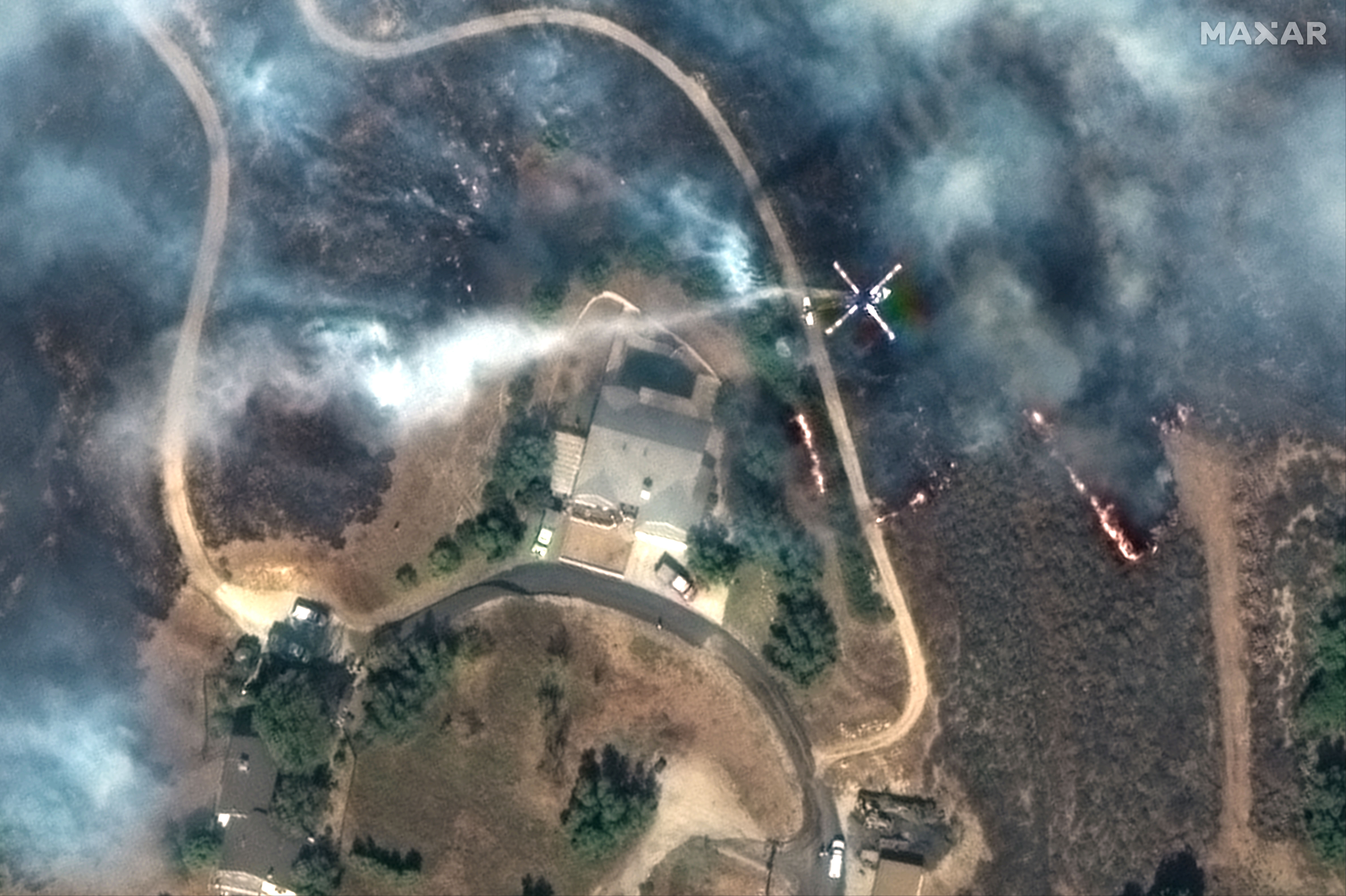 A satellite image of firefighting helicopter trying to protect a house near Moorpark.