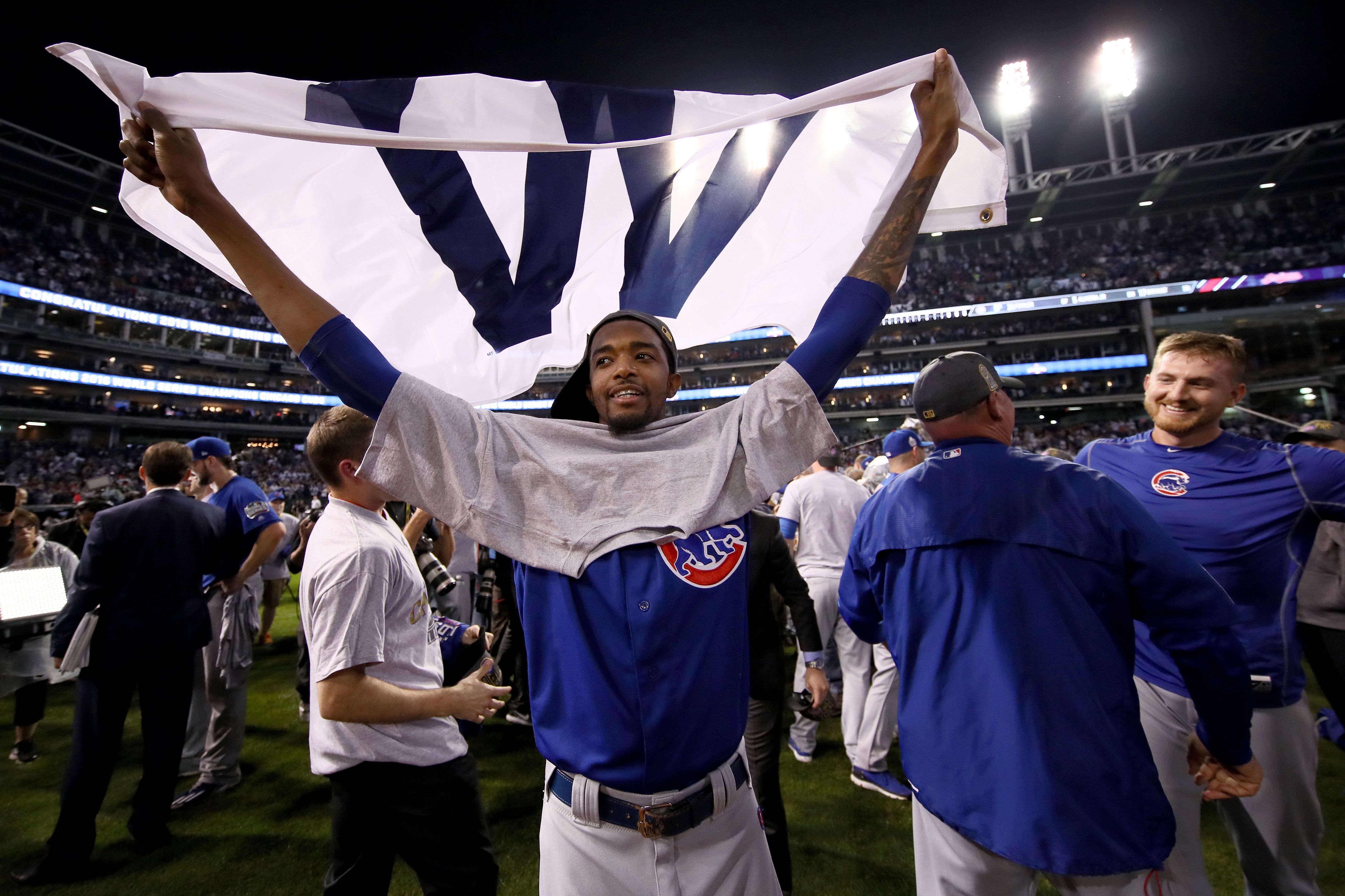 Photo of a baseball player waiving a flag in celebration