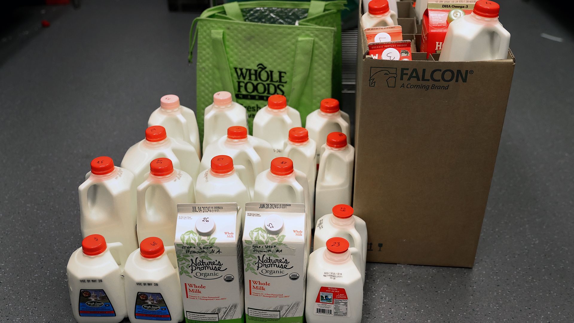 More than a dozen bottles or cartons of milk are visible 