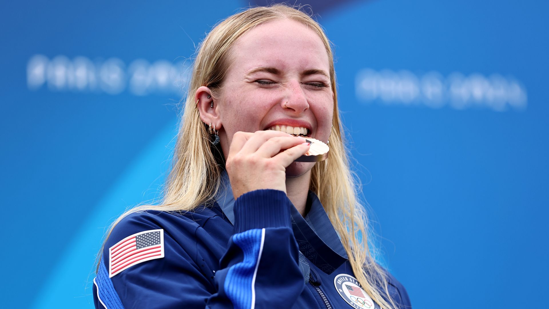 Evy Leibfarth bites her Olympic medal.