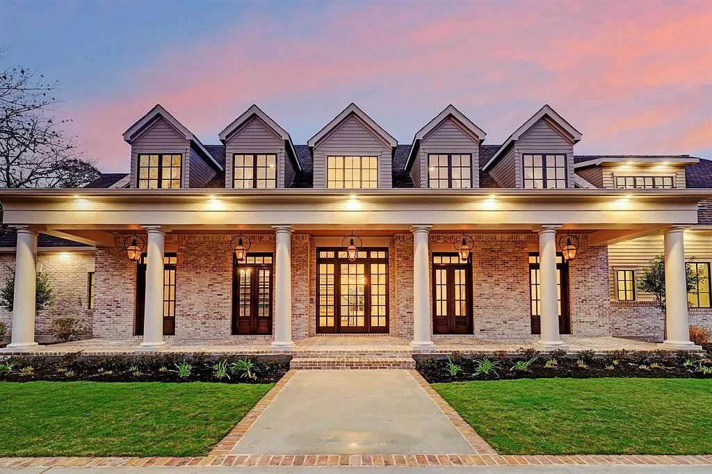 Photo of a white mansion with black windows. 