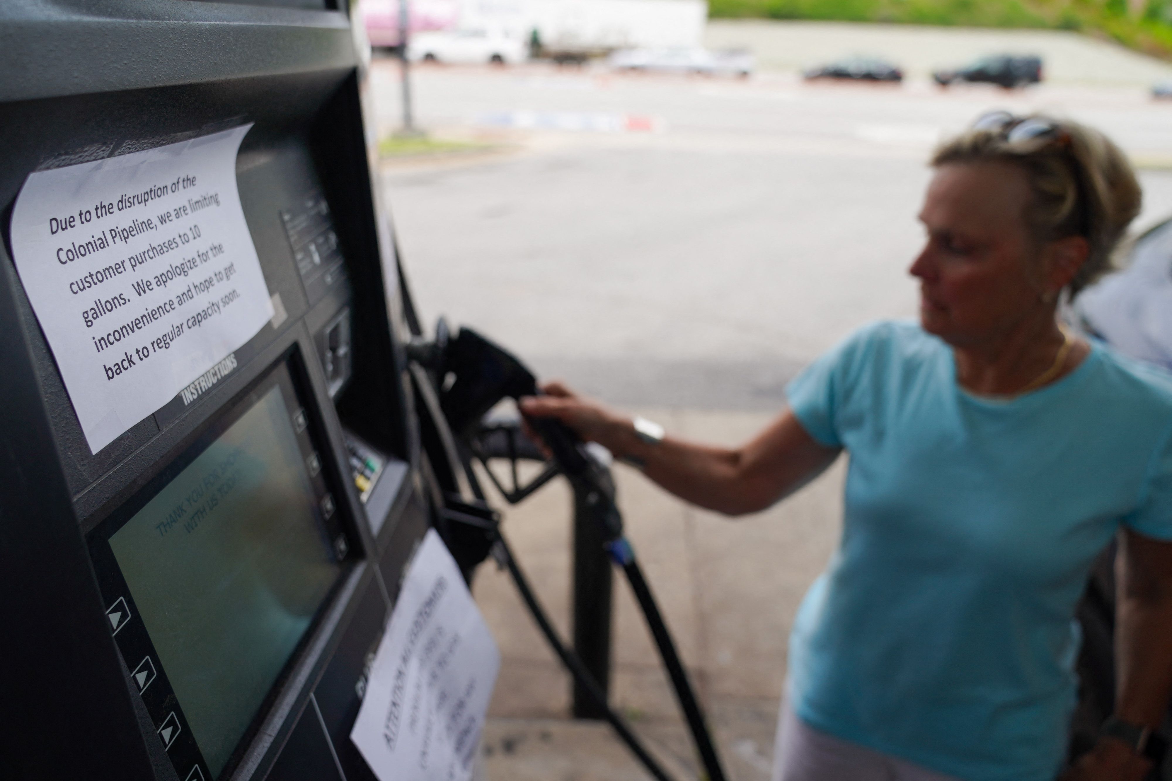 Signs to limit the puchase of gas from customers are seen on gas pumps at a Marathon gas station on May 11, 2021, in Smyrna, Georgia. 