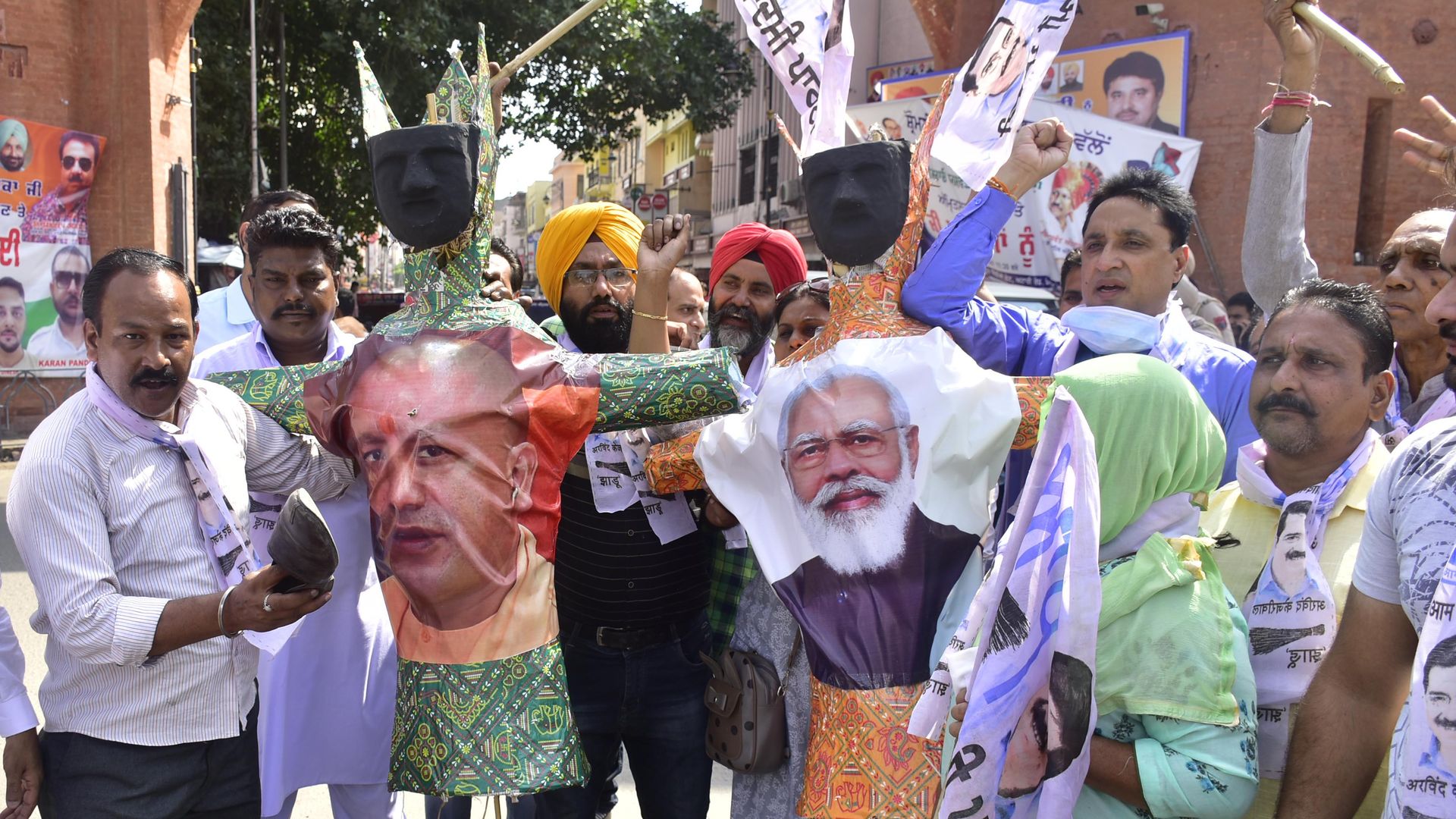 Farmers shout carry effigies to burn with the pictures of India's Prime Minister Narendra Modi and others during a protest in Lakhimpur Kheri, on October 5, 2021 in Amritsar, India.