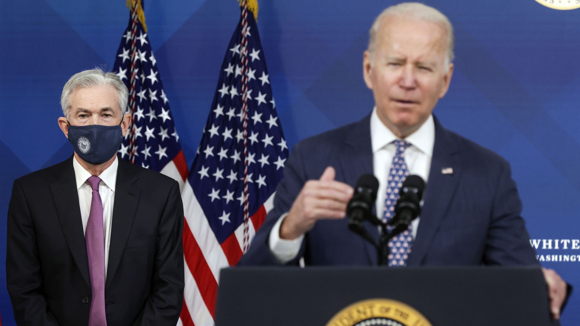 President Joe Biden speaks with Federal Reserve Board Chair Jerome Powell in the background