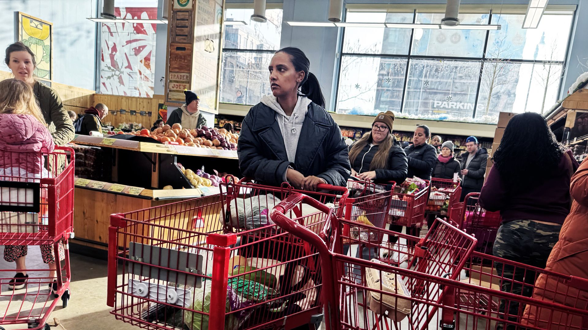 Shoppers wait in line at a grocery store in Washington, D.C., ahead of a winter storm expected to hit the region over the weekend, on Friday, January 23, 2026.