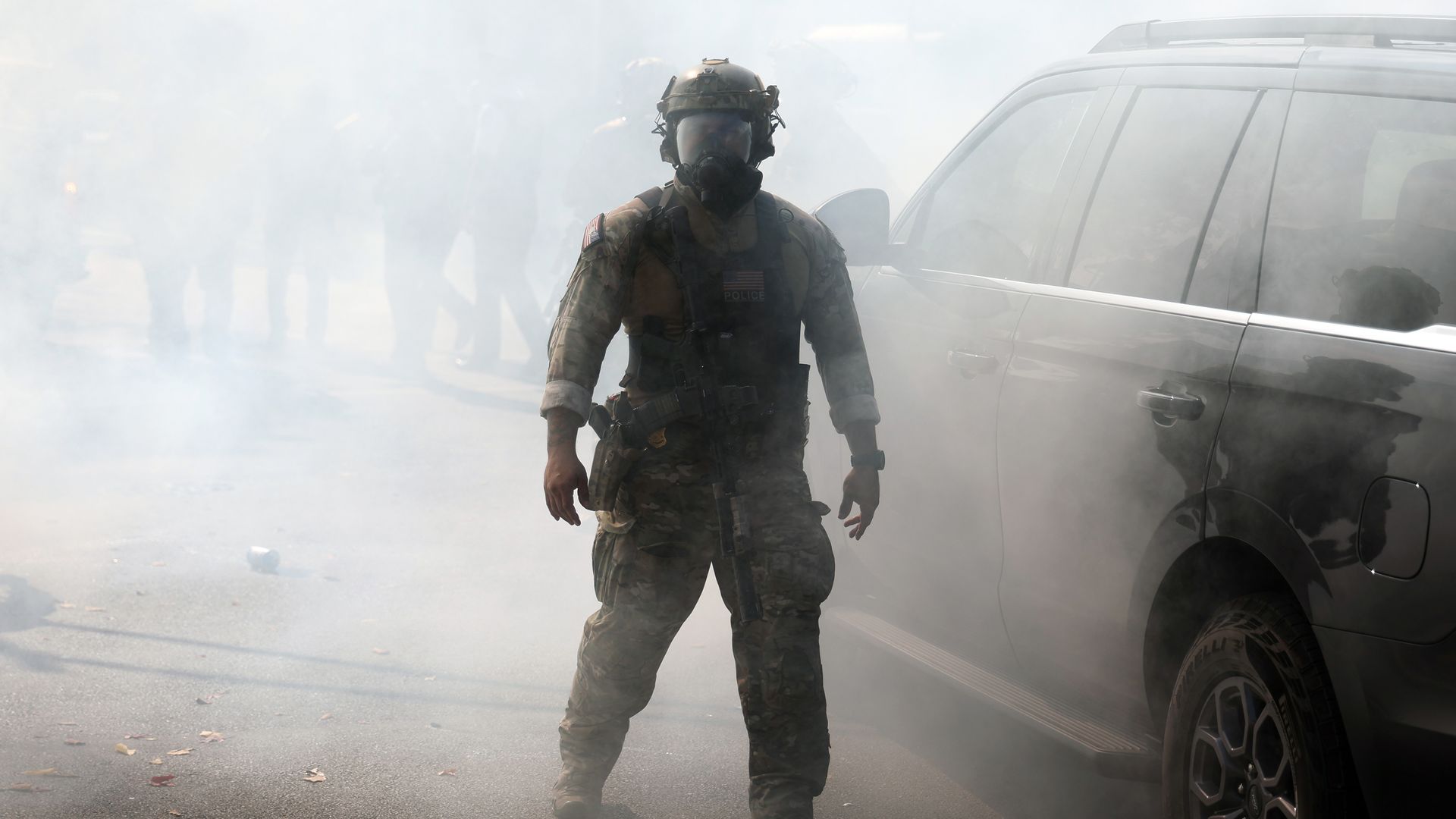 Border Patrol agent walks through tear gas 