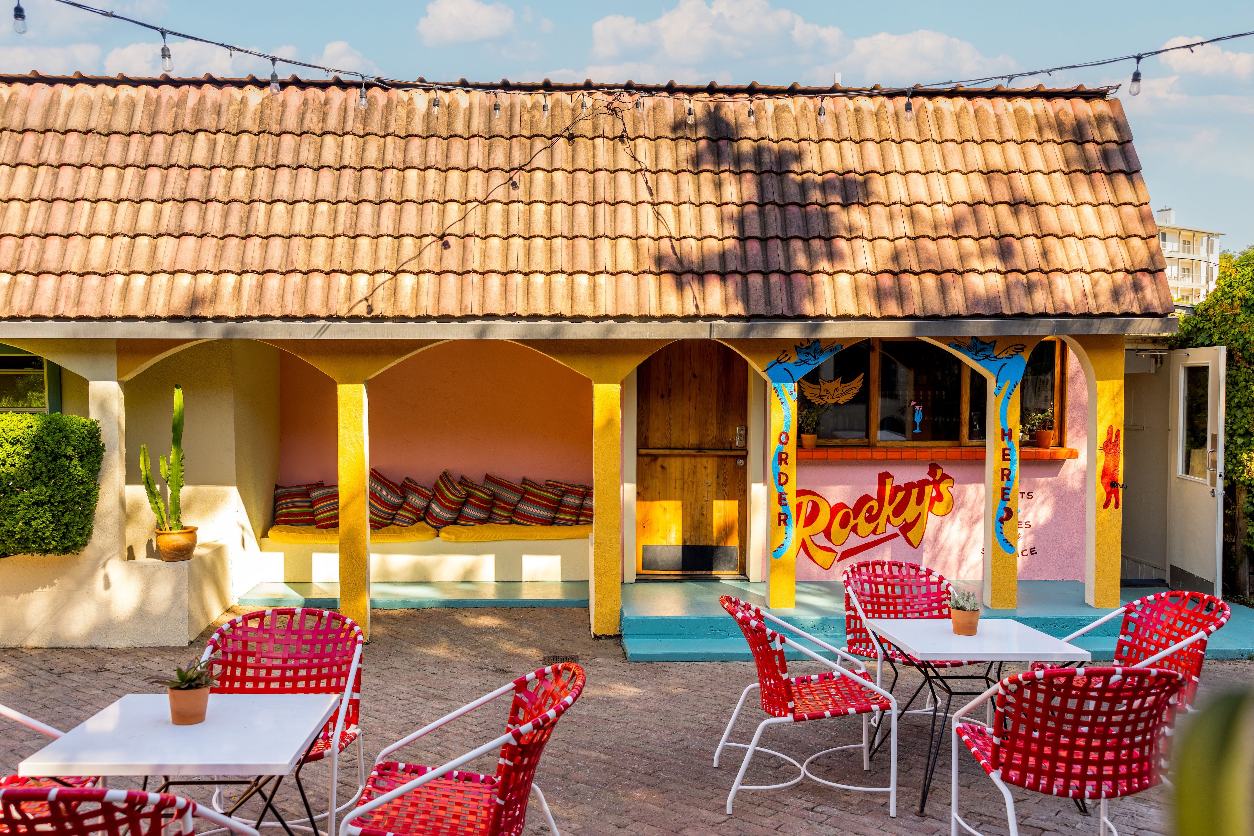 A photo of a yellow building with the words "Rocky's Bar."