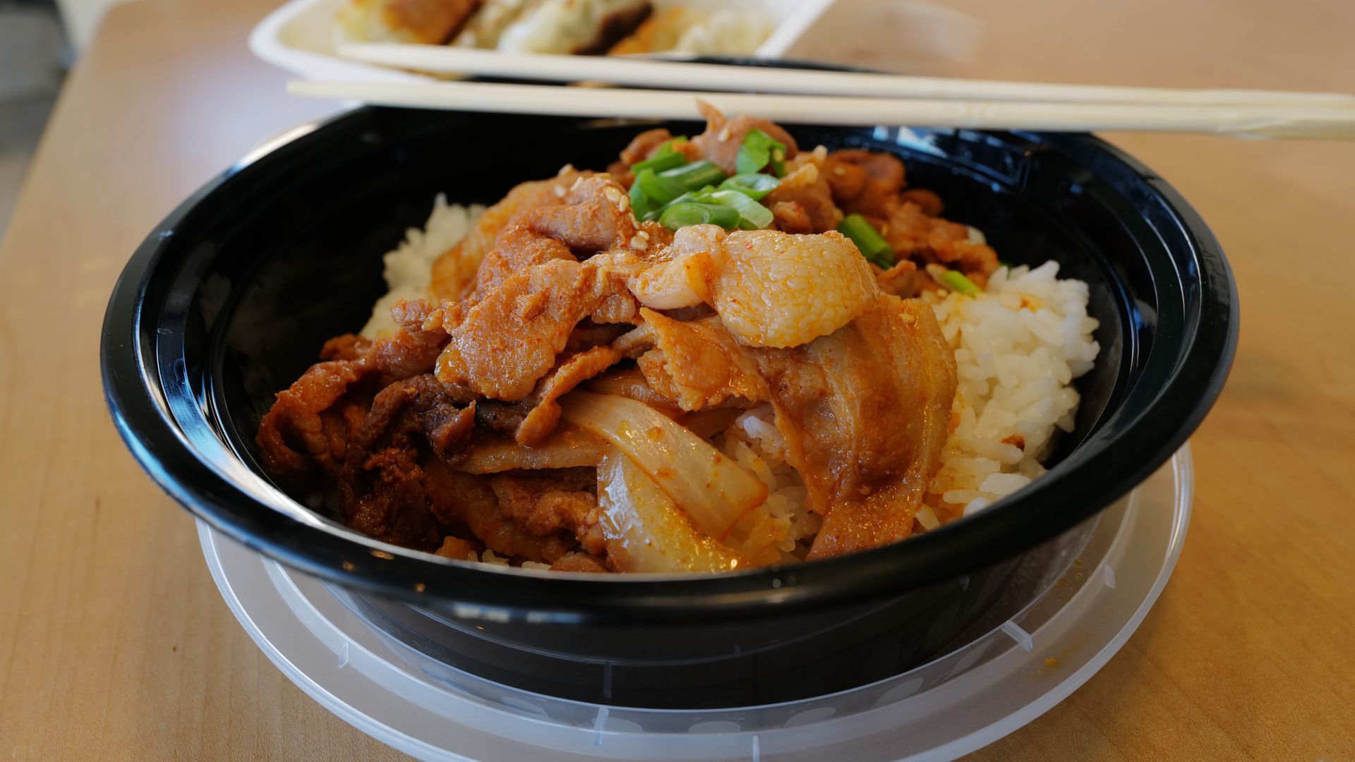 bowl of rice and bulgogi meat with chopsticks on top