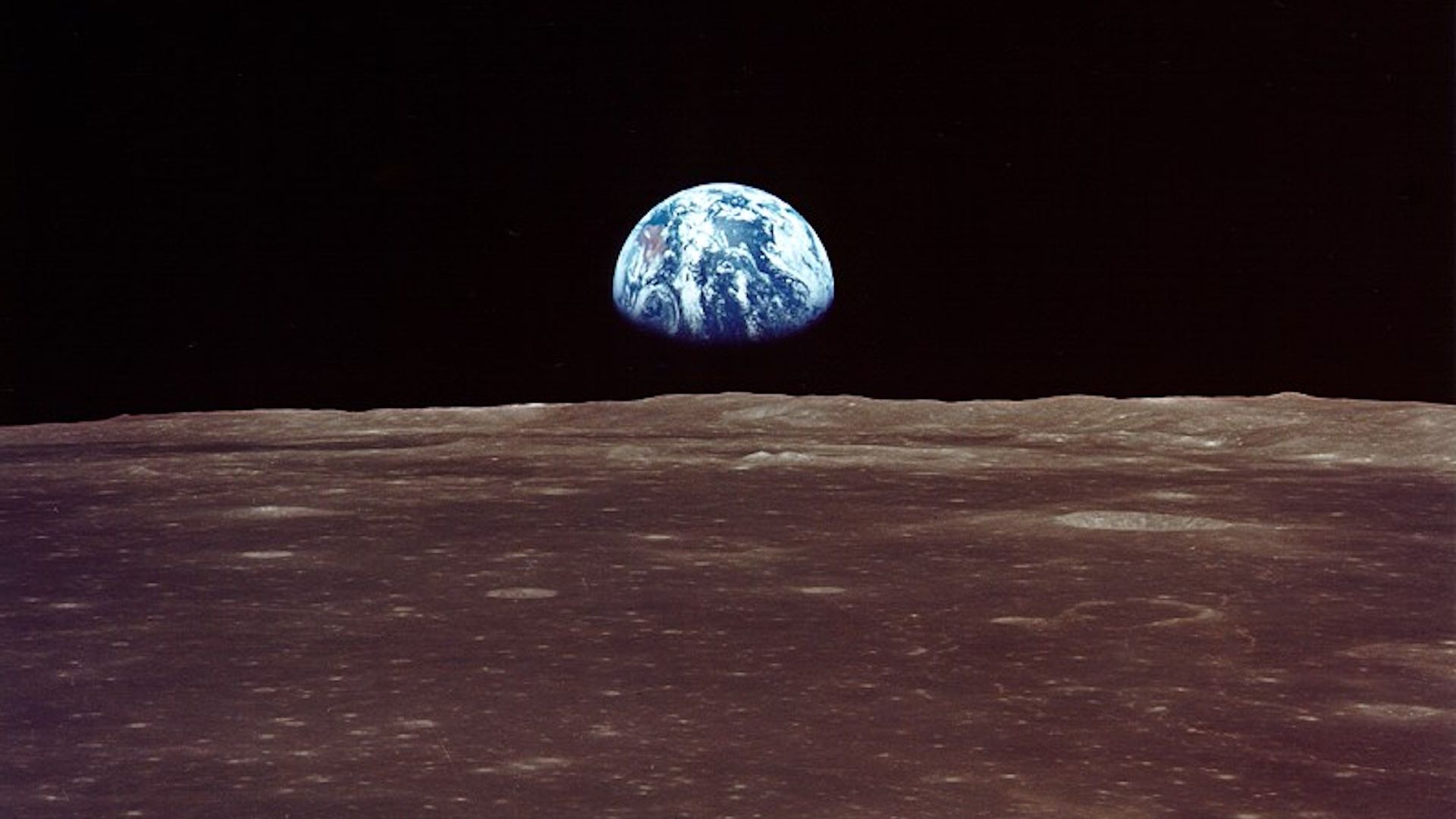 The Earth appearing over the limb of the Moon.