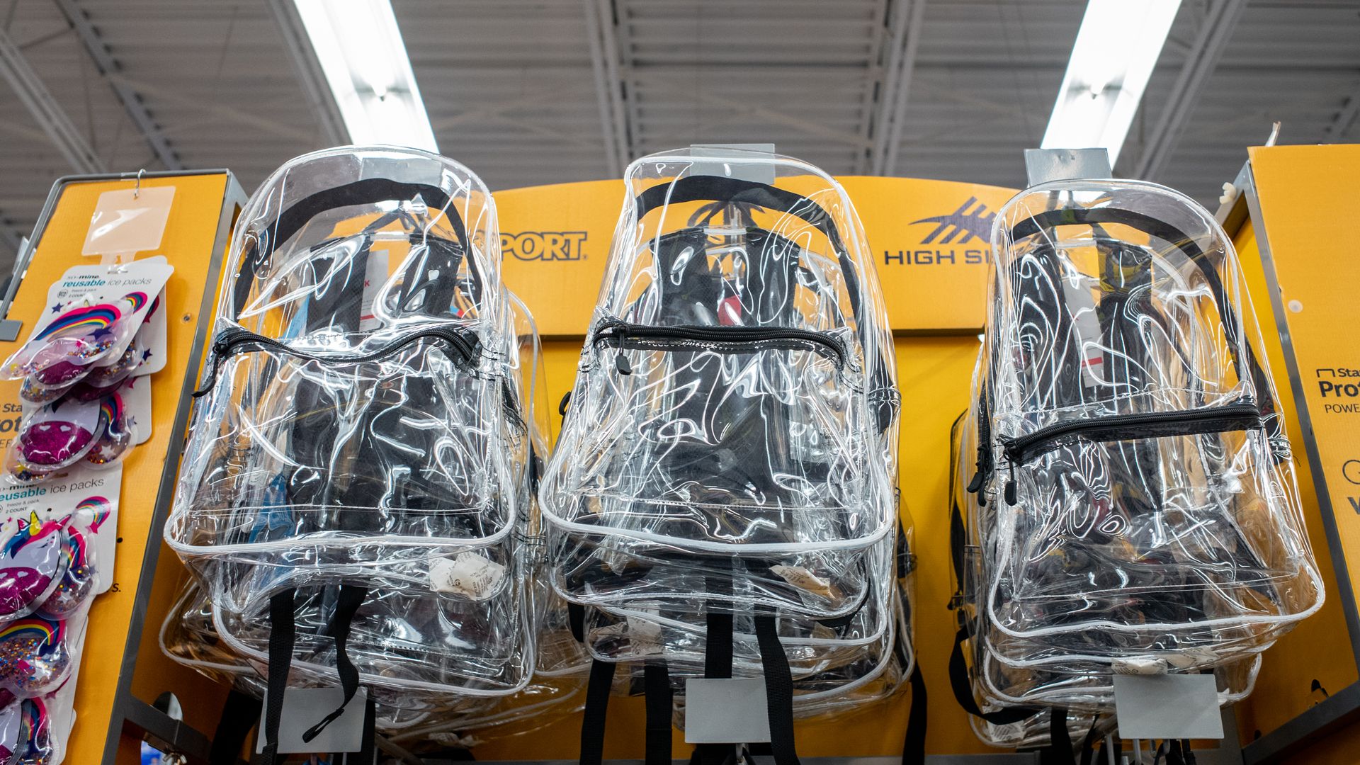 Clear backpacks on display inside a store.