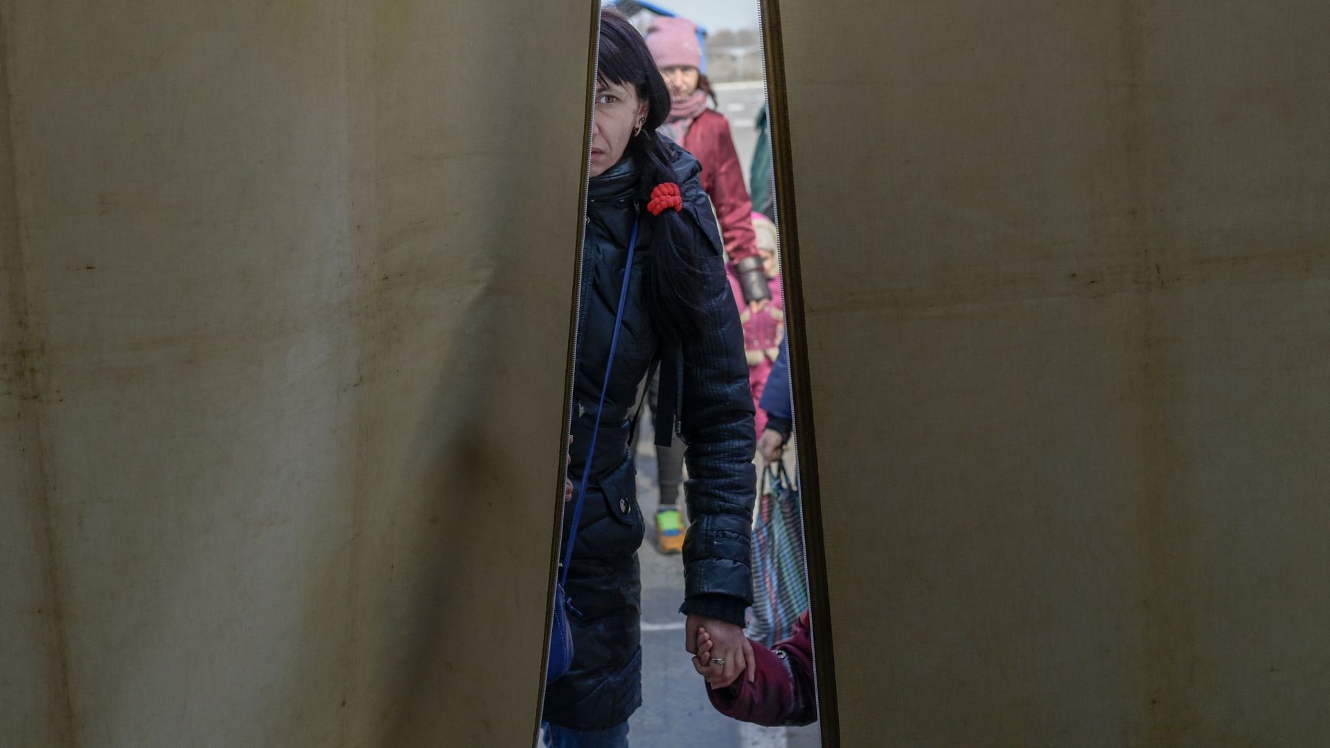 A woman with her children arrives at at a displaced persons' hub in Zaporizhzhia, some 200 kilometres (124 miles) northwest of Mariupol, on April 5.