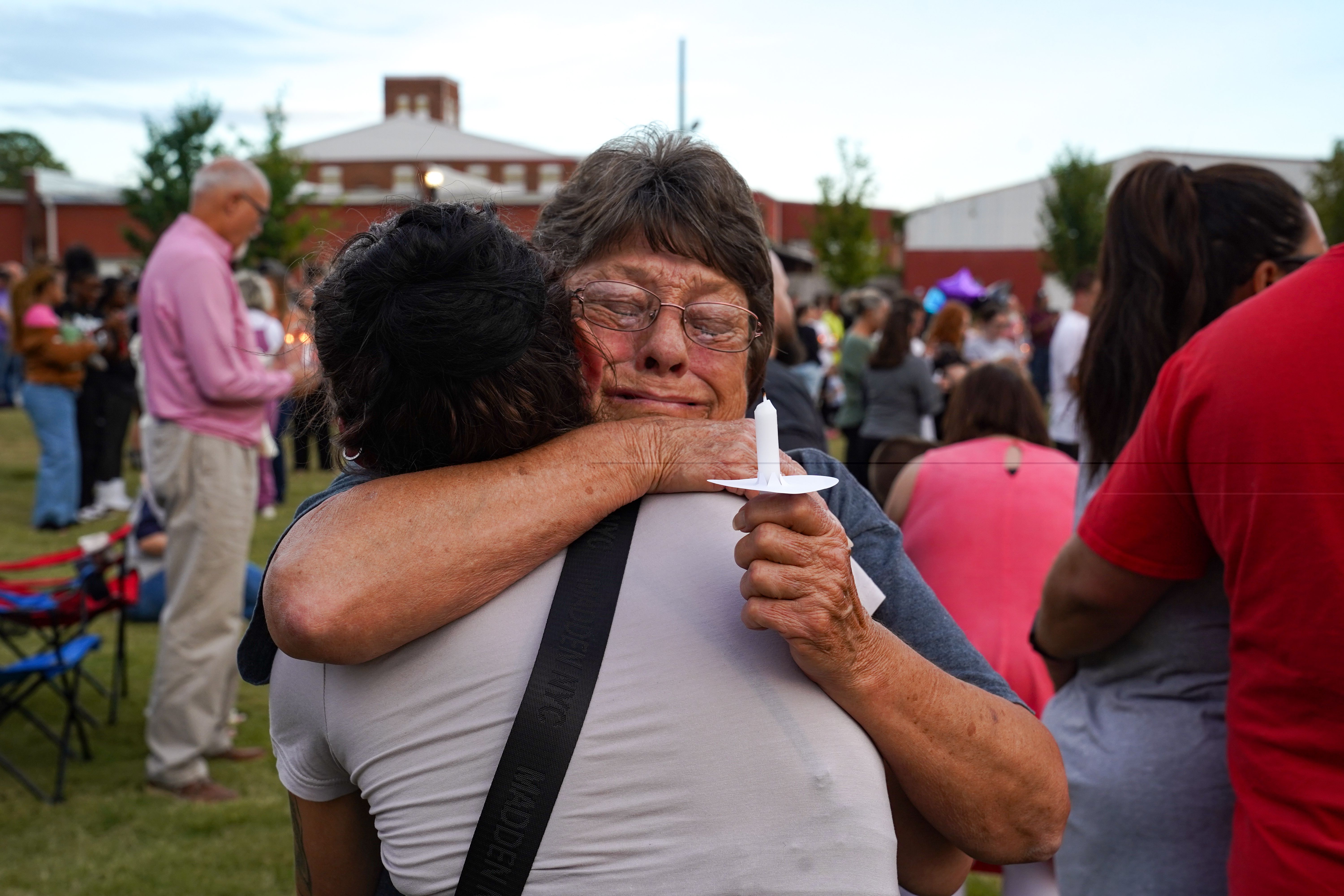 Two women embrace as students, faculty and community members gather for a vigil after a shooting at Apalachee High School on September 4, 2024 in Winder, Georgia.