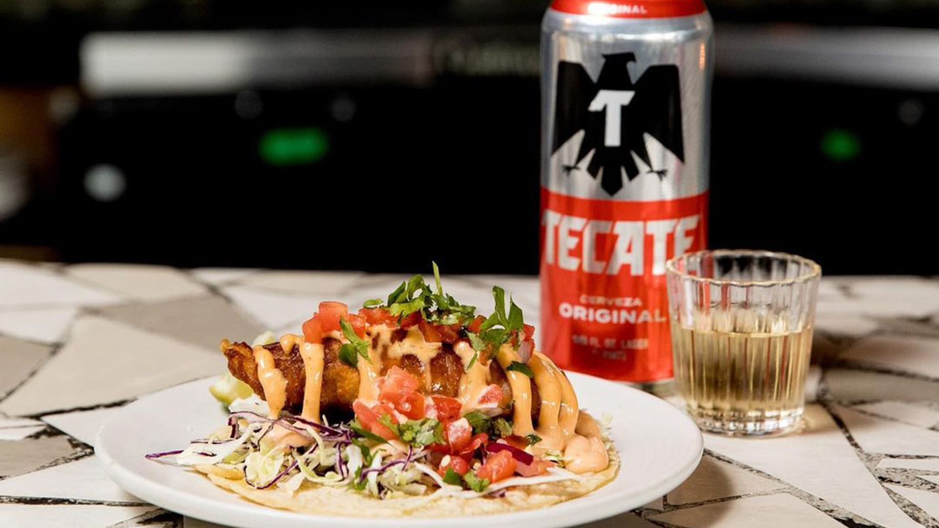 Can of tecate, tequila, and tacov