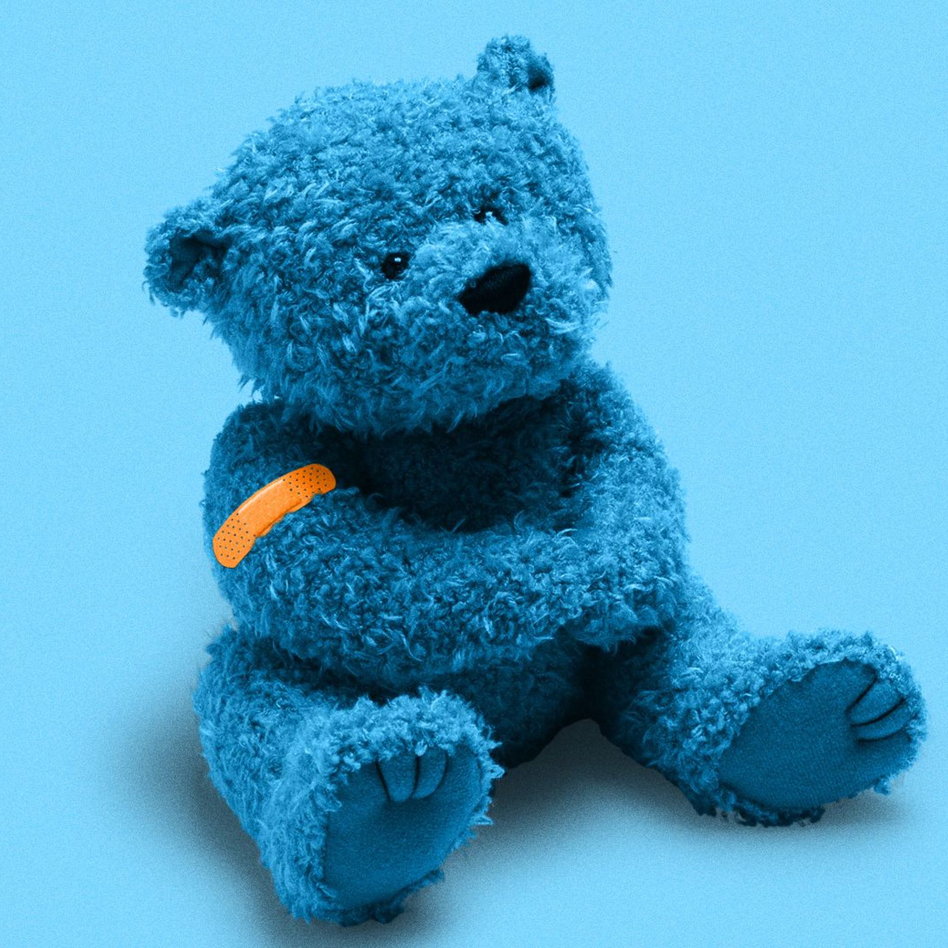 Illustration of a blue teddy bear with orange band-aid on its arm. 