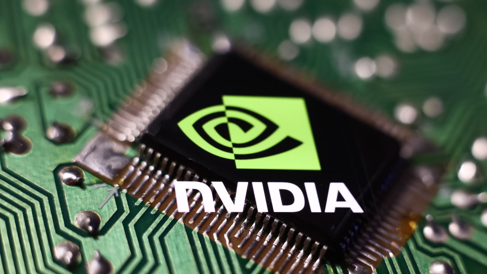 A Nvidia logo over a computer chip.
