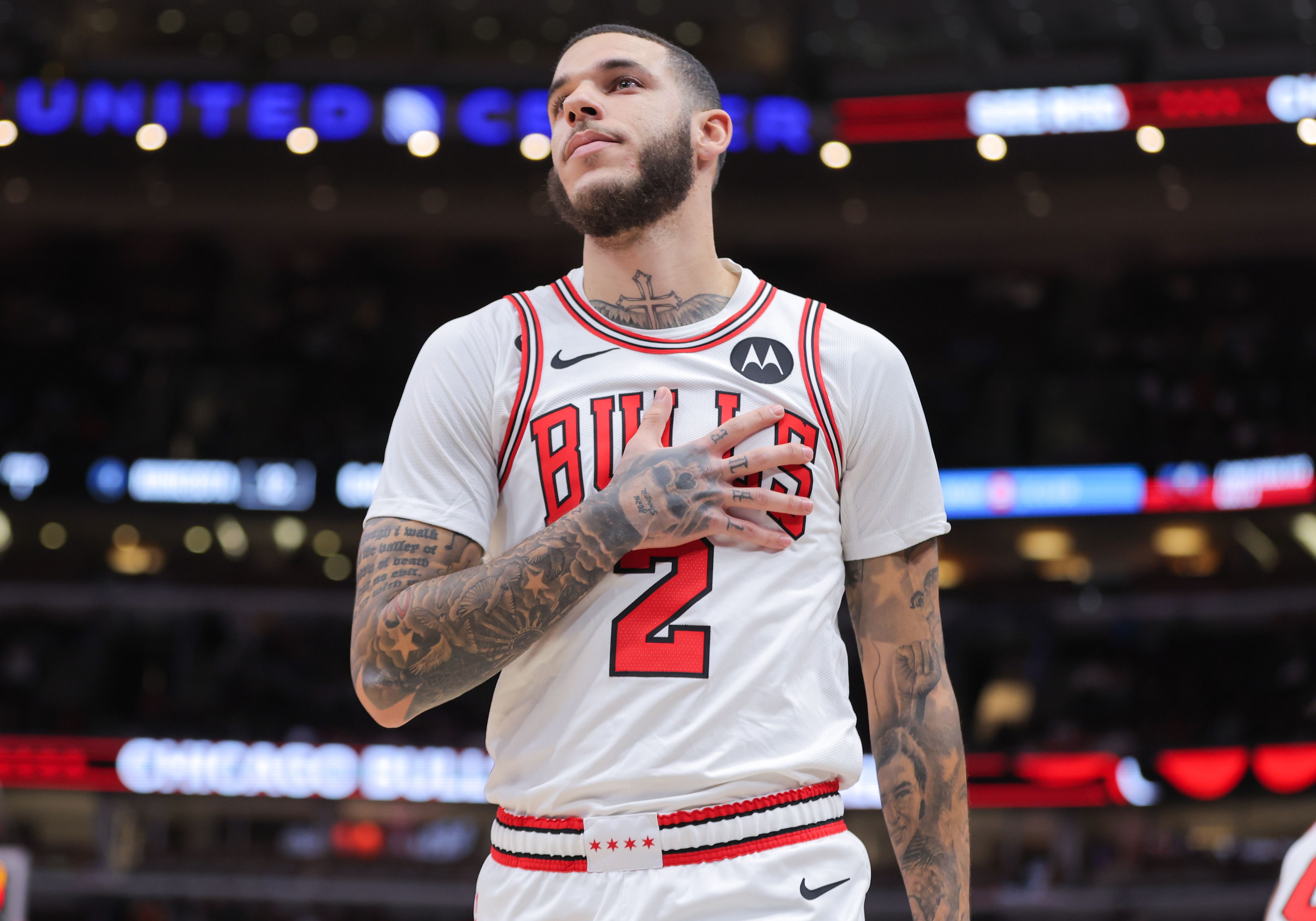 Photo of a basketball player motioning to his chest during a game on a court 