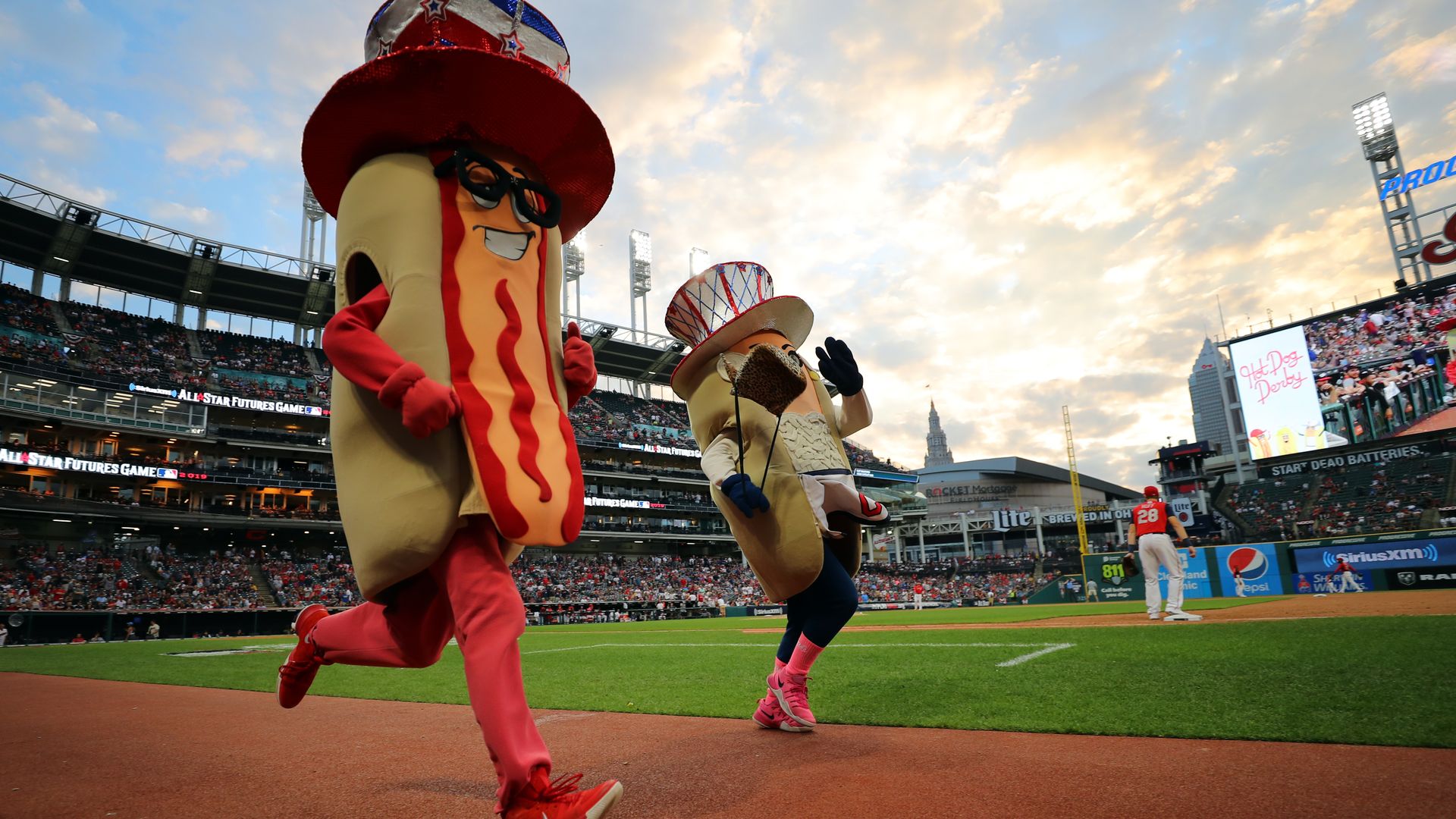 Two runners in hot dog costumes are seen at Progressive Field.