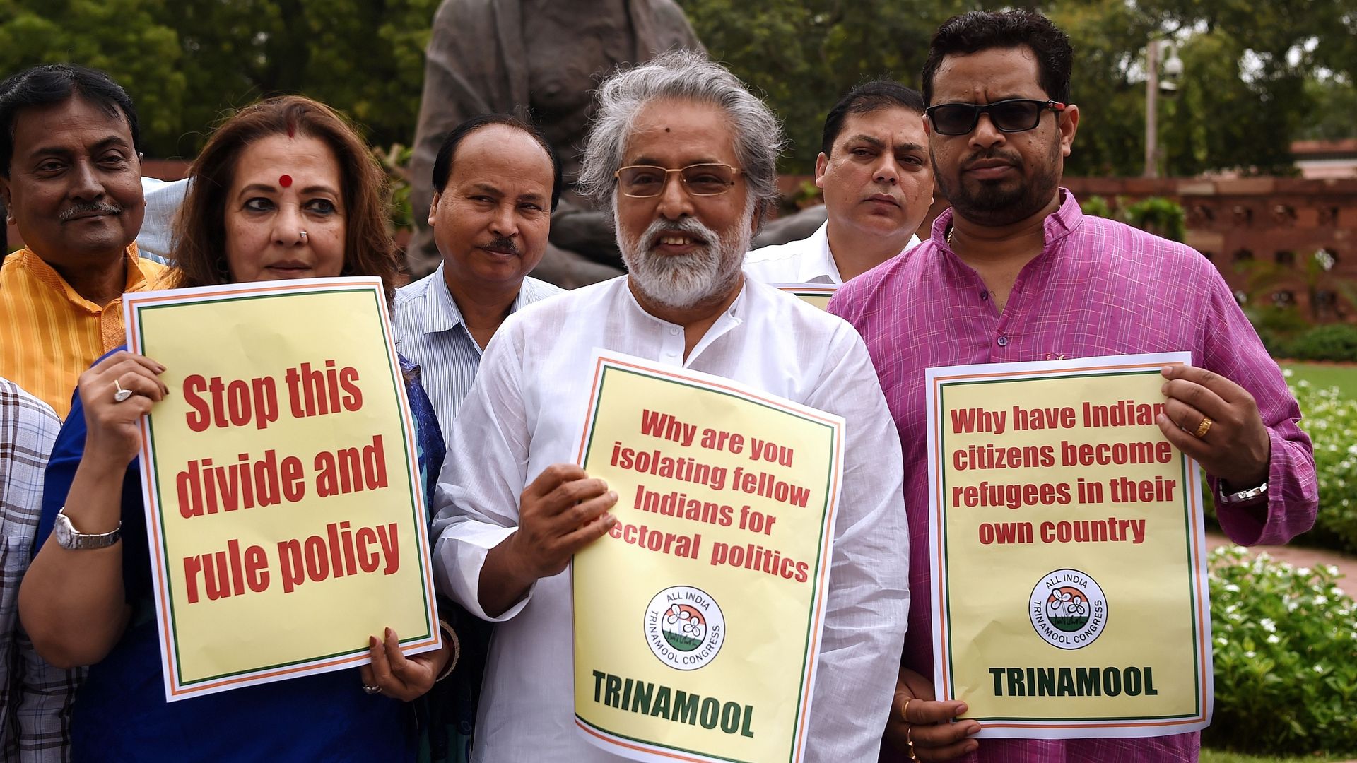 Members of Parliament hold placards against the non-inclusion of over 40 lakh people in Assam's National Register of Citizens during a protest in Parliament in New Delhi on July 31, 2018.